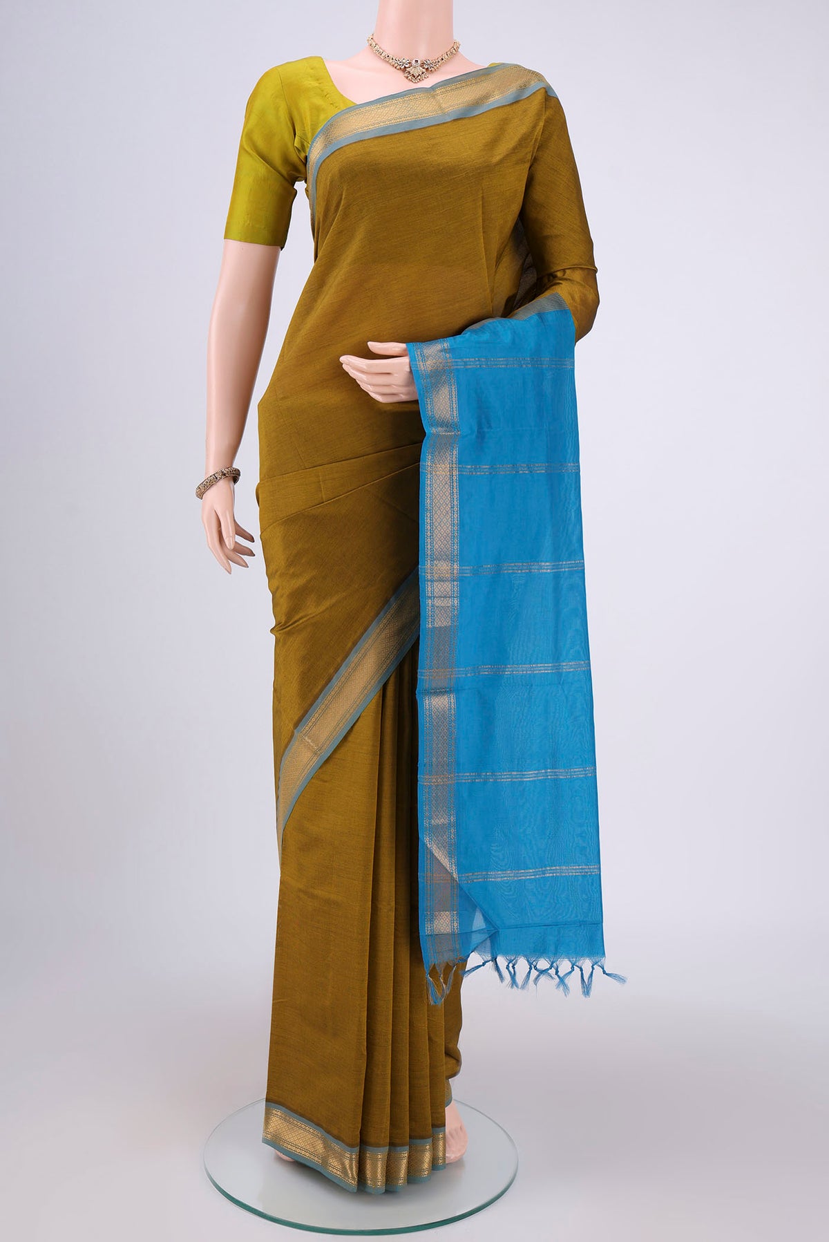 Blue Blended Poly Cotton Saree with Zari Butta on the body and Zari Border.  displayed on a mannequin