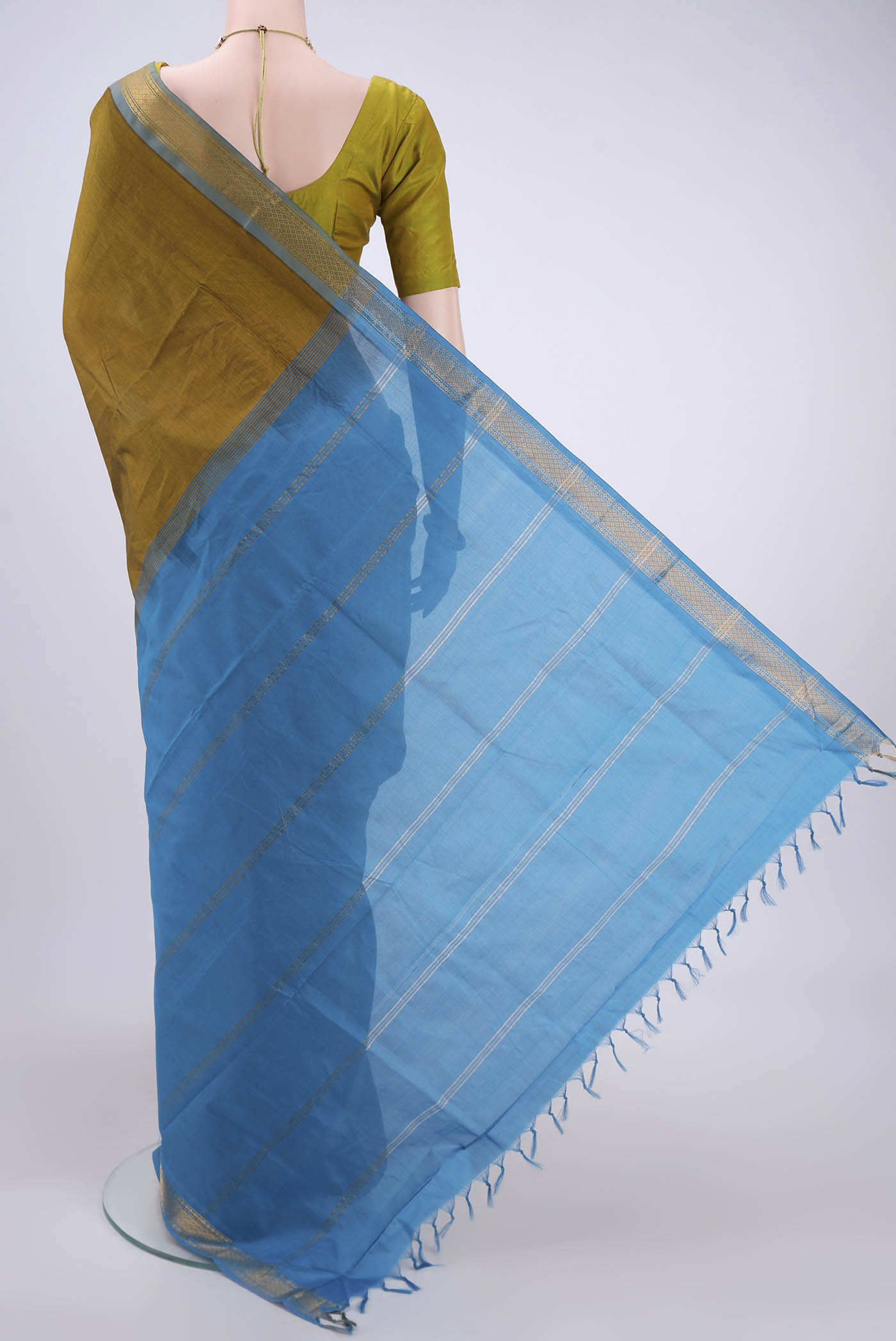 Flat view of Blue Blended Poly Cotton Saree with Zari Butta on the body and Zari Border. 