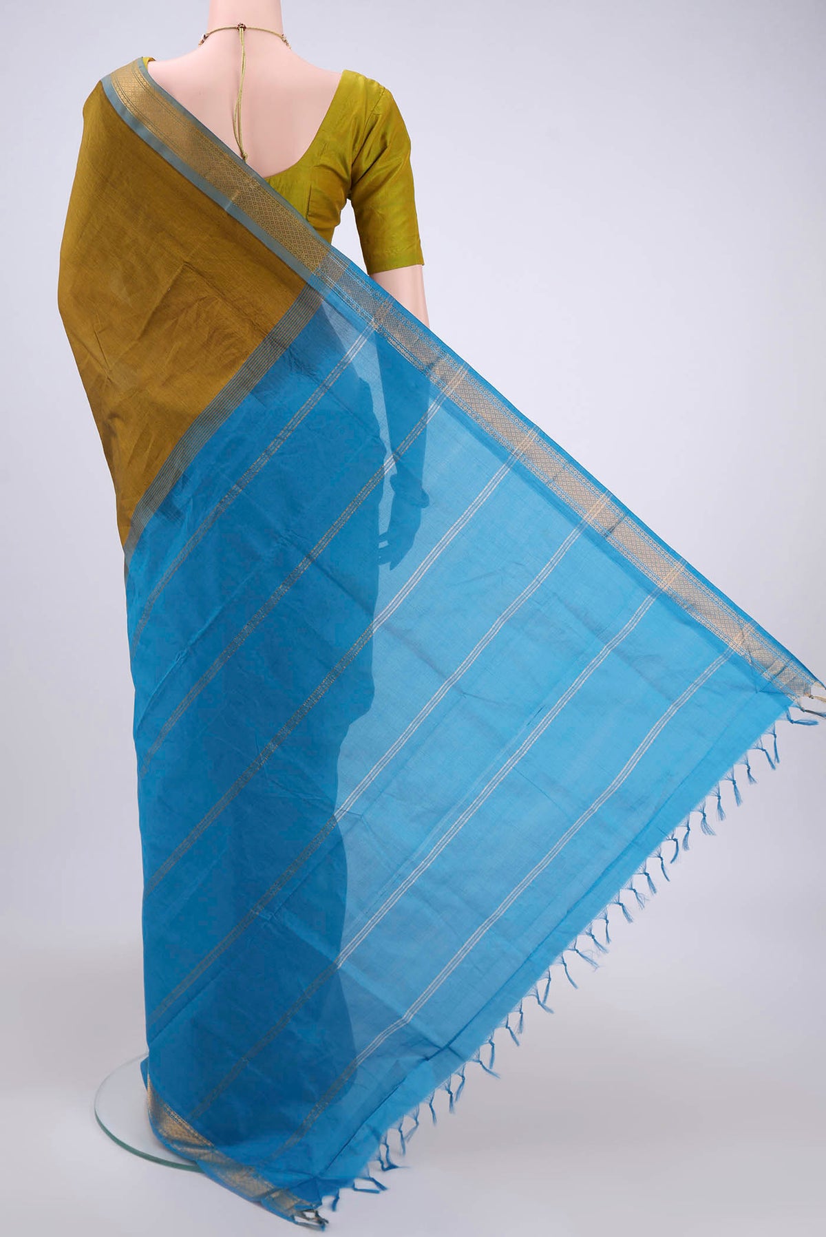 Flat view of Blue Blended Poly Cotton Saree with Zari Butta on the body and Zari Border. 