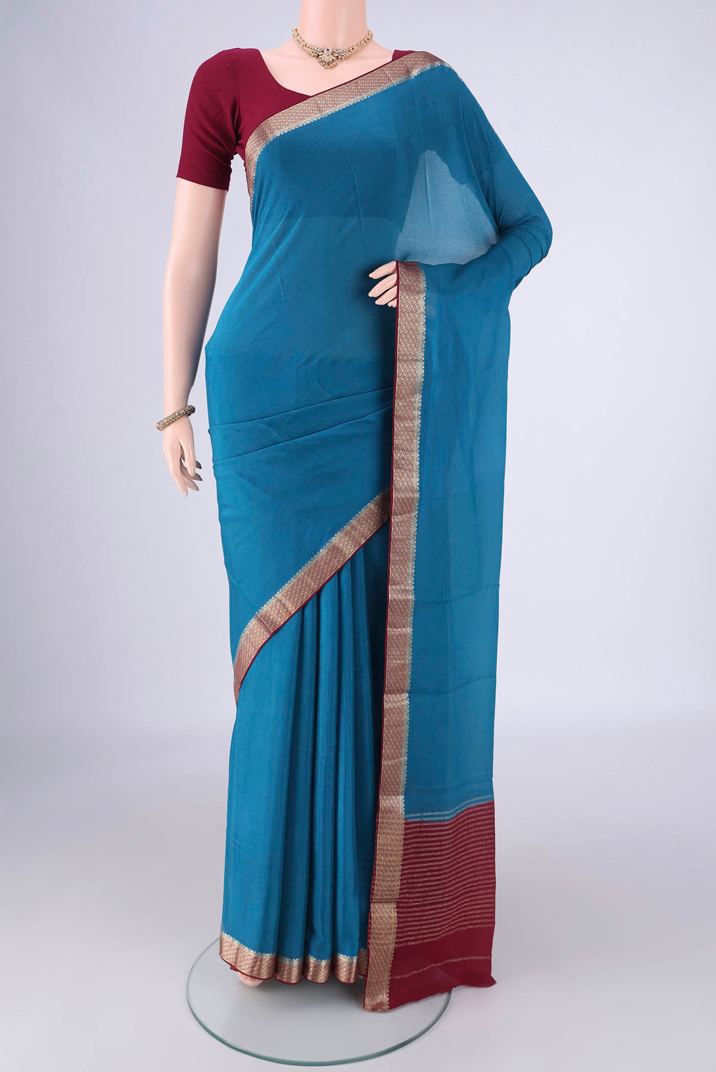 Blue Mysore Chiffon Saree with Plain Body and Zari Border.  displayed on a mannequin