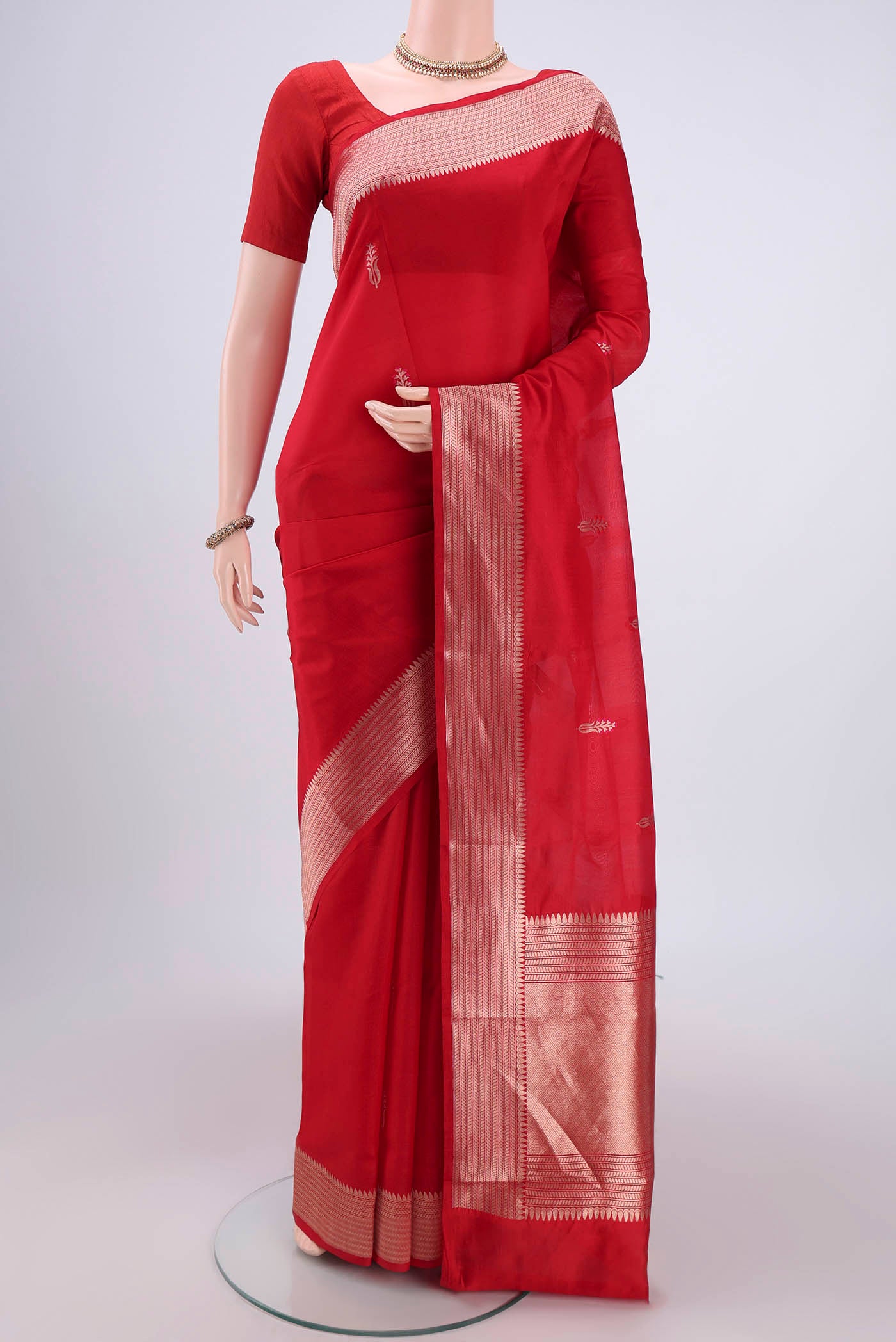 Deep Red Banarasi Katan Silk Saree with Zari Butta on the body and Zari Border.  displayed on a mannequin