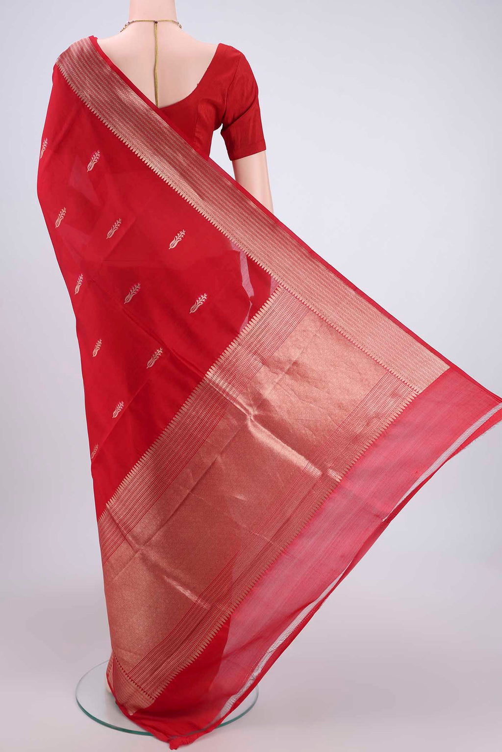Flat view of Deep Red Banarasi Katan Silk Saree with Zari Butta on the body and Zari Border. 