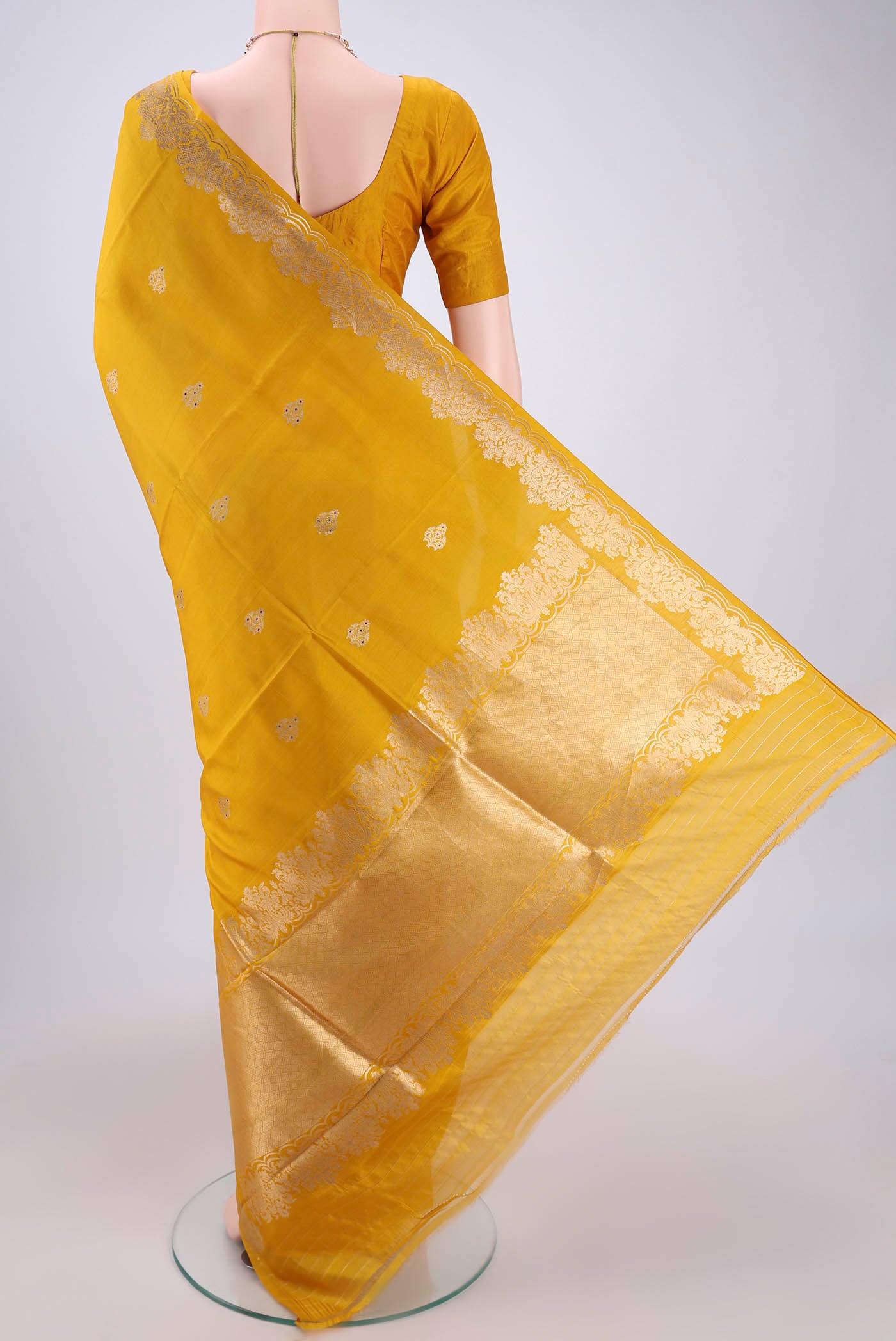 Flat view of Yellow Banarasi Katan Silk Saree with Zari Butta on the body and Zari Border. 