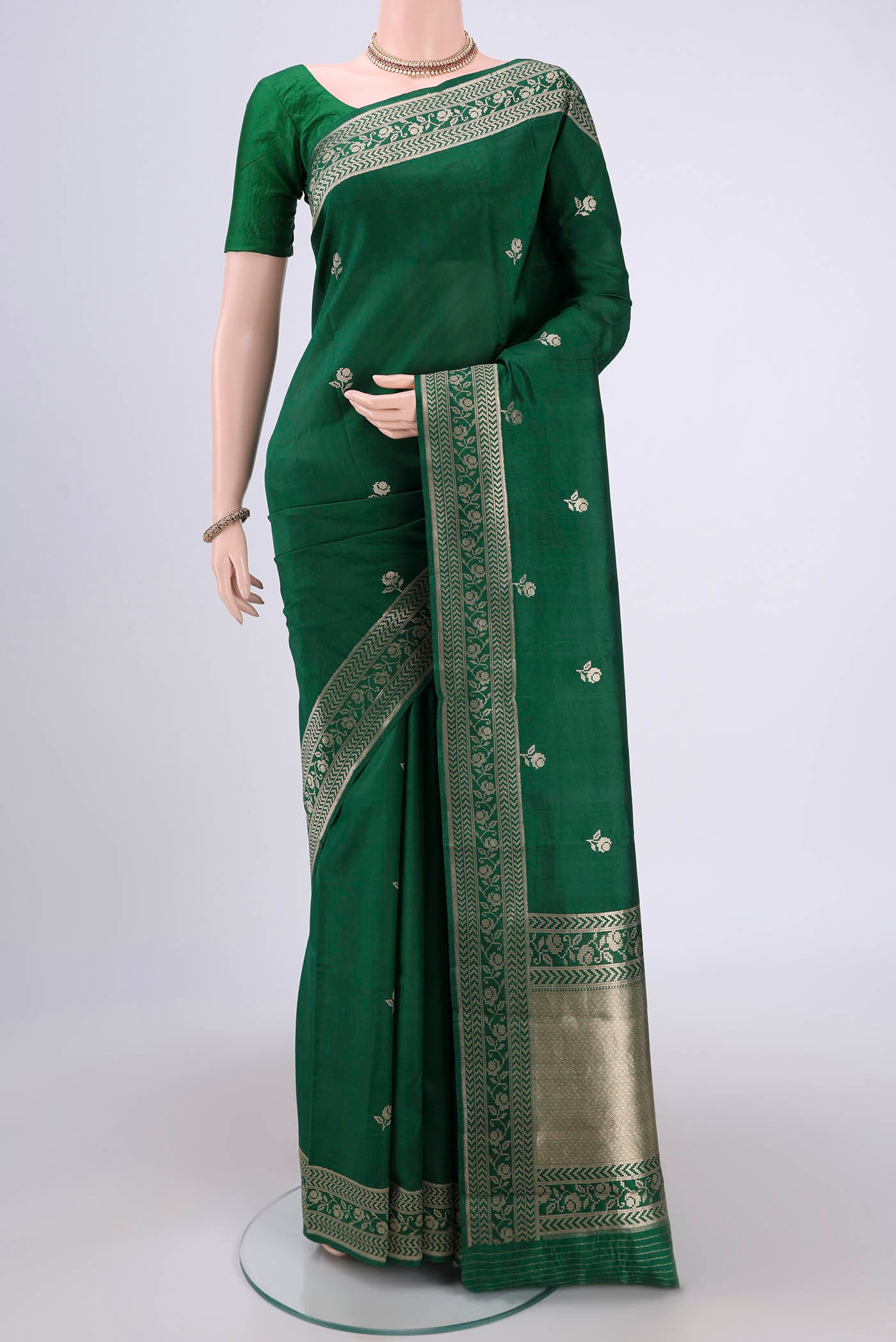 Green Banarasi Katan Silk Saree with Zari Butta on the body and Zari Border.  displayed on a mannequin