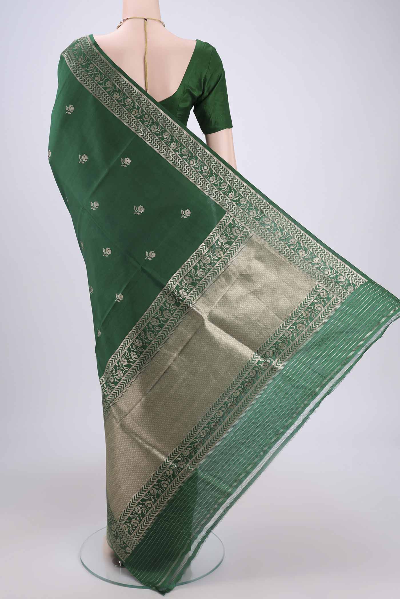 Flat view of Green Banarasi Katan Silk Saree with Zari Butta on the body and Zari Border. 