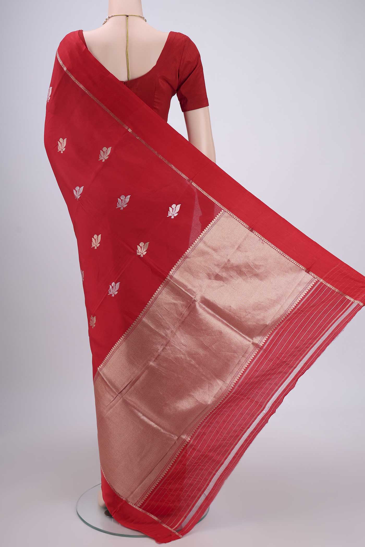 Flat view of Red Banarasi Katan Silk Saree with Zari Butta on the body and Zari Border. 