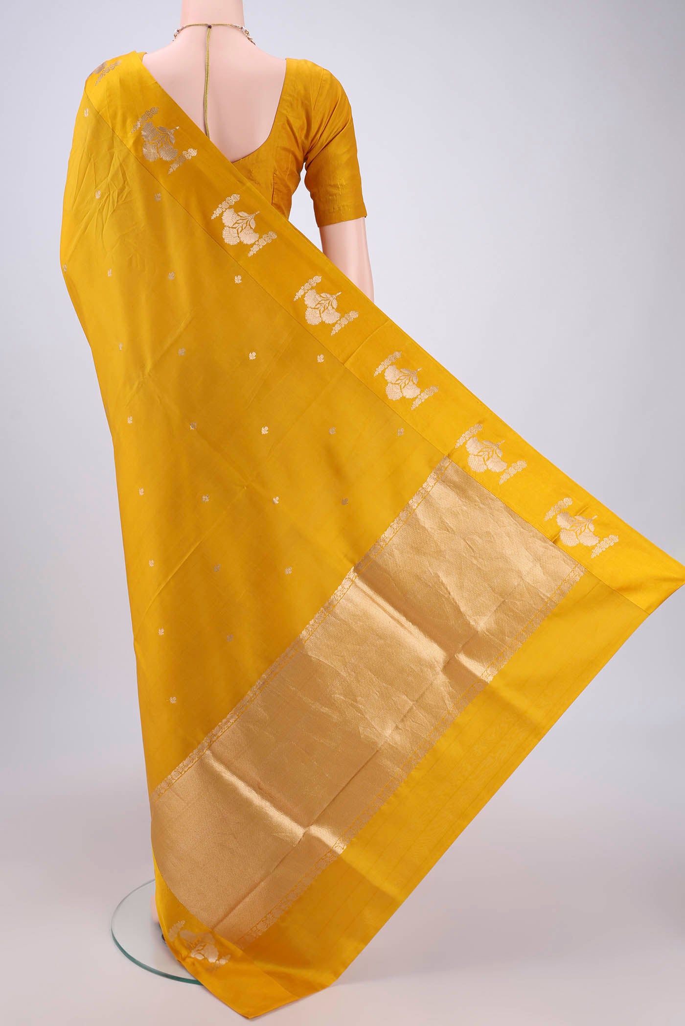 Flat view of Yellow Banarasi Katan Silk Saree with Zari Butta on the body and Zari Border. 