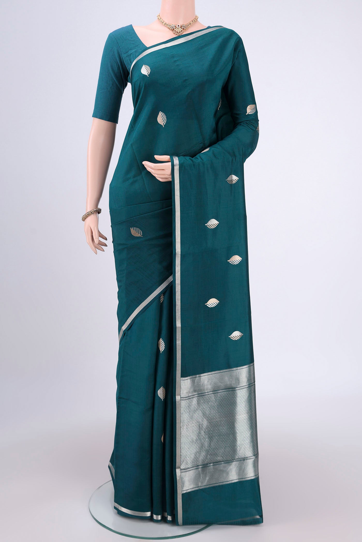Green Banarasi Katan Silk Saree with Zari Butta on the body and Zari Border.  displayed on a mannequin