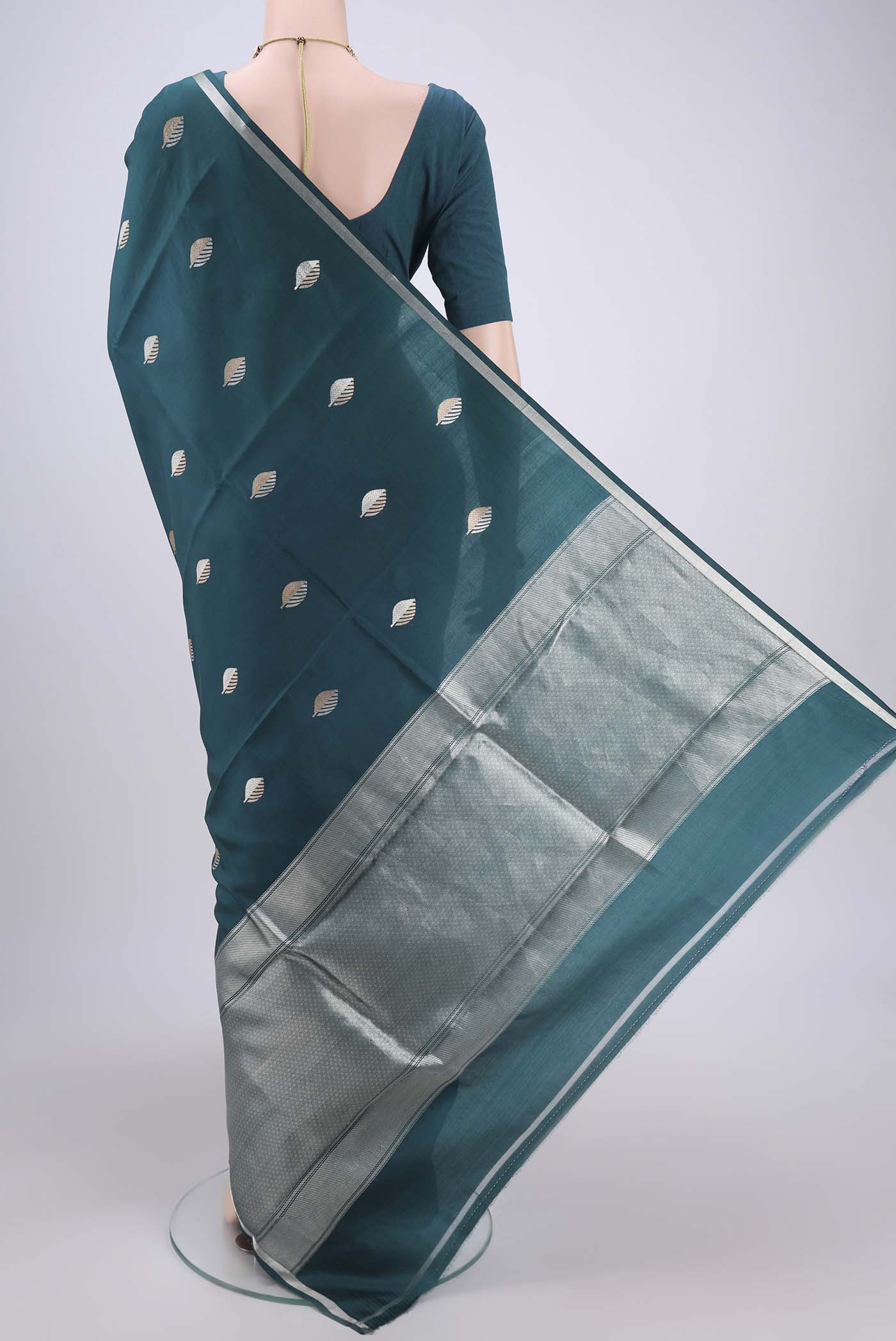 Flat view of Green Banarasi Katan Silk Saree with Zari Butta on the body and Zari Border. 