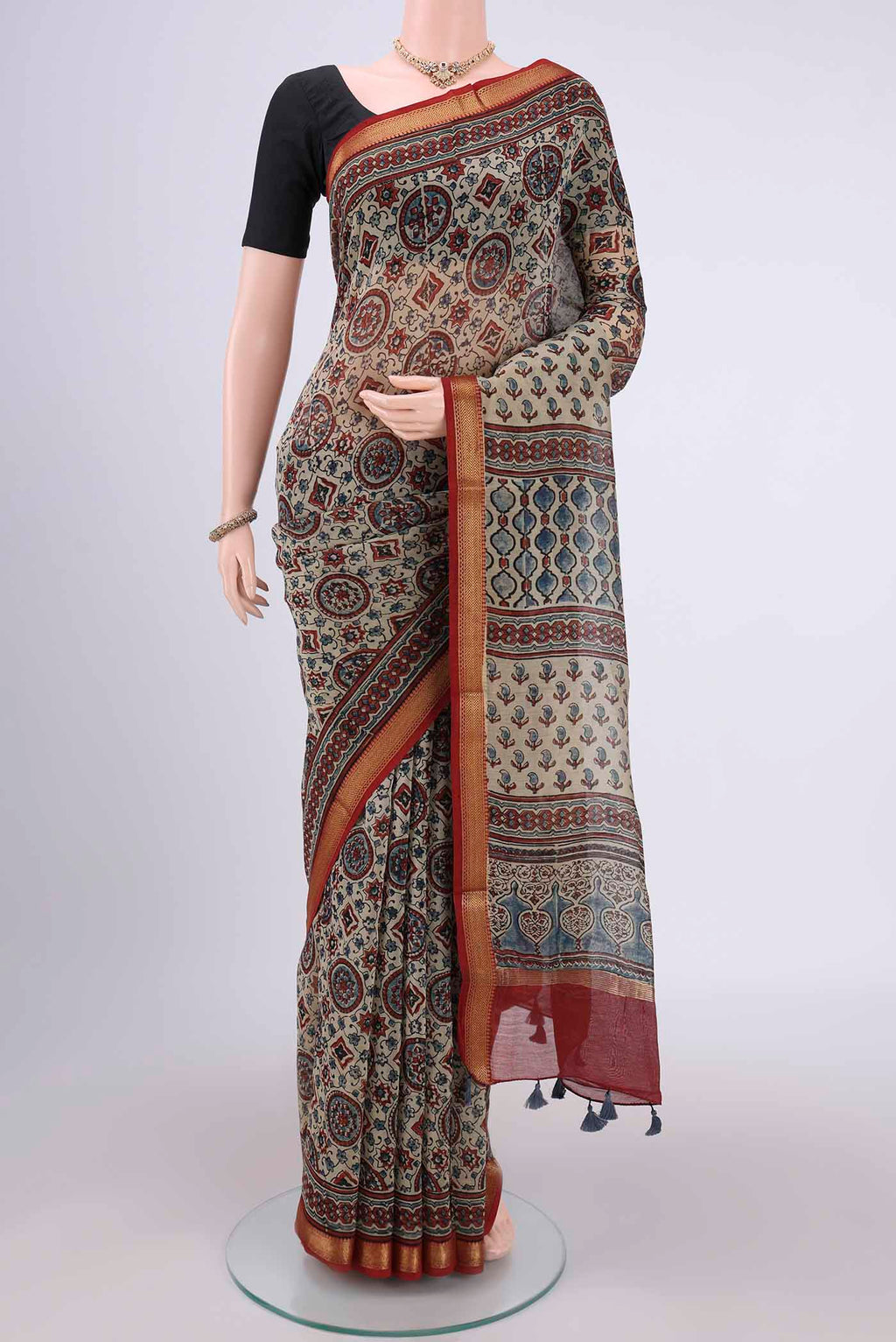 Beige Chanderi Silk Cotton Saree with Ajrakh Print on the body and Zari Border.  displayed on a mannequin