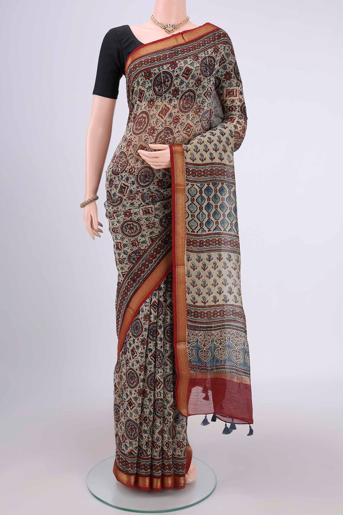 Beige Chanderi Silk Cotton Saree with Ajrakh Print on the body and Zari Border.  displayed on a mannequin