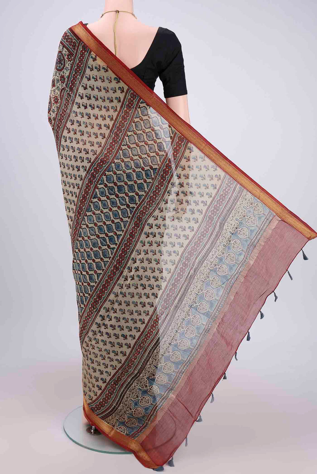 Flat view of Beige Chanderi Silk Cotton Saree with Ajrakh Print on the body and Zari Border. 