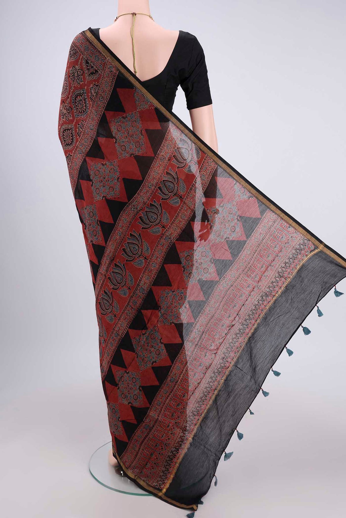 Flat view of Maroon Chanderi Silk Cotton Saree with Ajrakh Print on the body and Zari Border. 