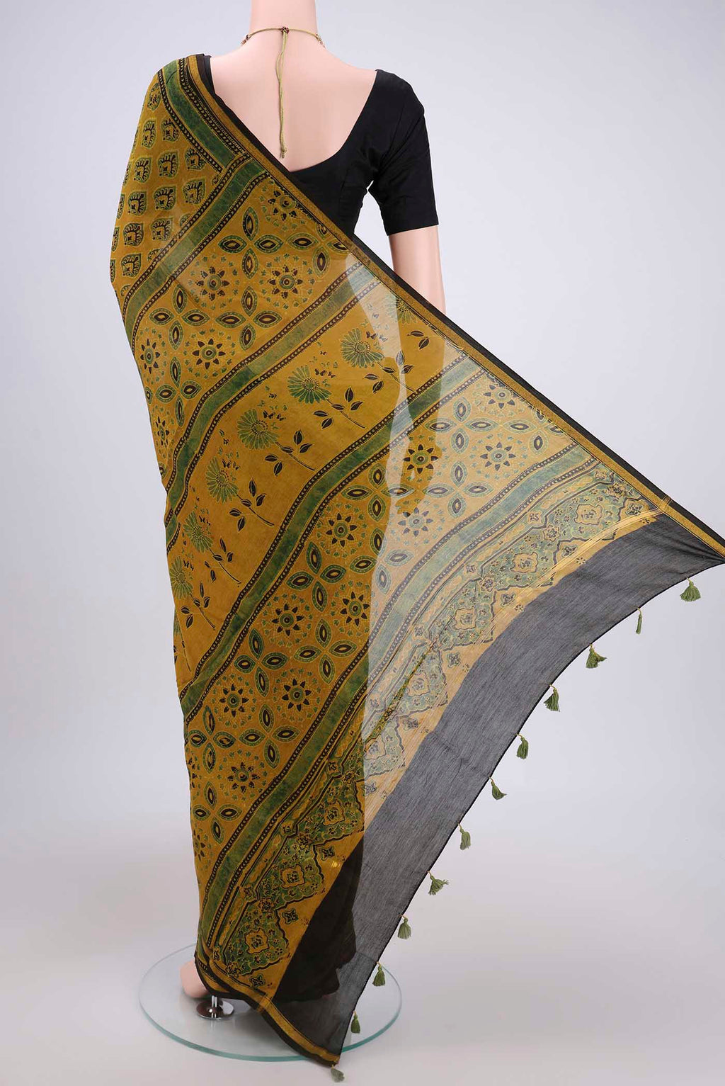 Flat view of Yellow Chanderi Silk Cotton Saree with Ajrakh Print on the body and Zari Border. 