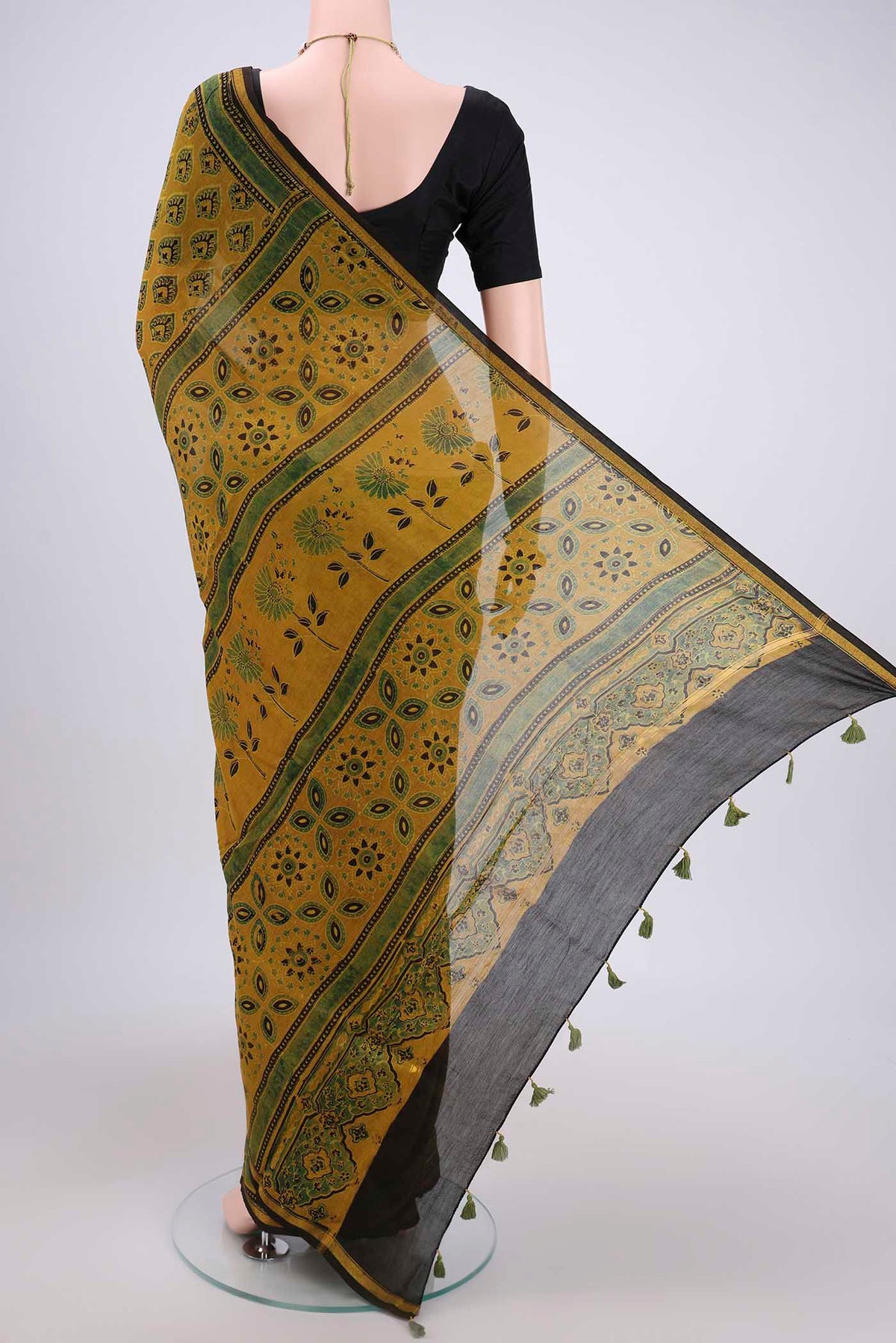 Flat view of Yellow Chanderi Silk Cotton Saree with Ajrakh Print on the body and Zari Border. 