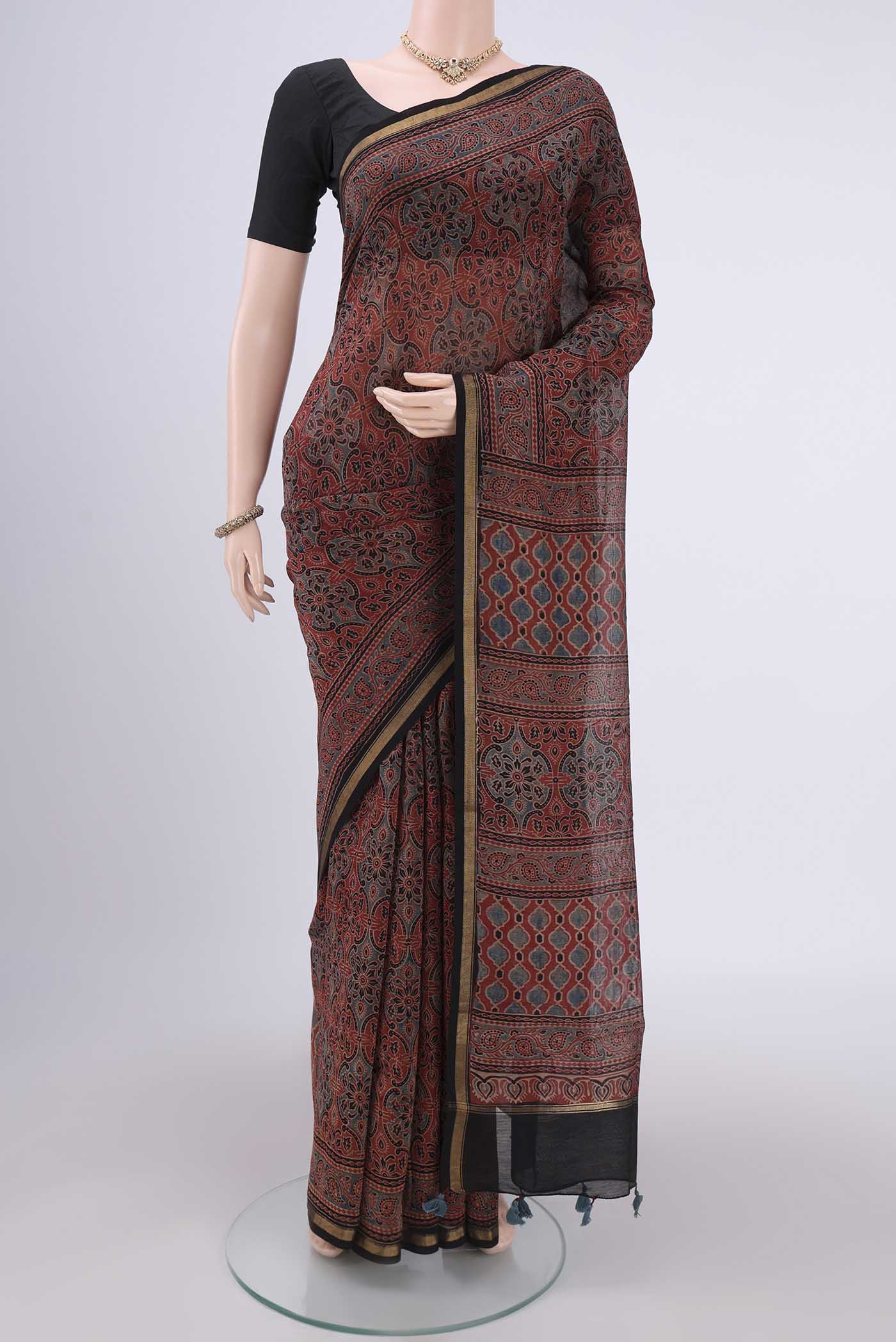 Maroon Chanderi Silk Cotton Saree with Ajrakh Print on the body and Zari Border.  displayed on a mannequin