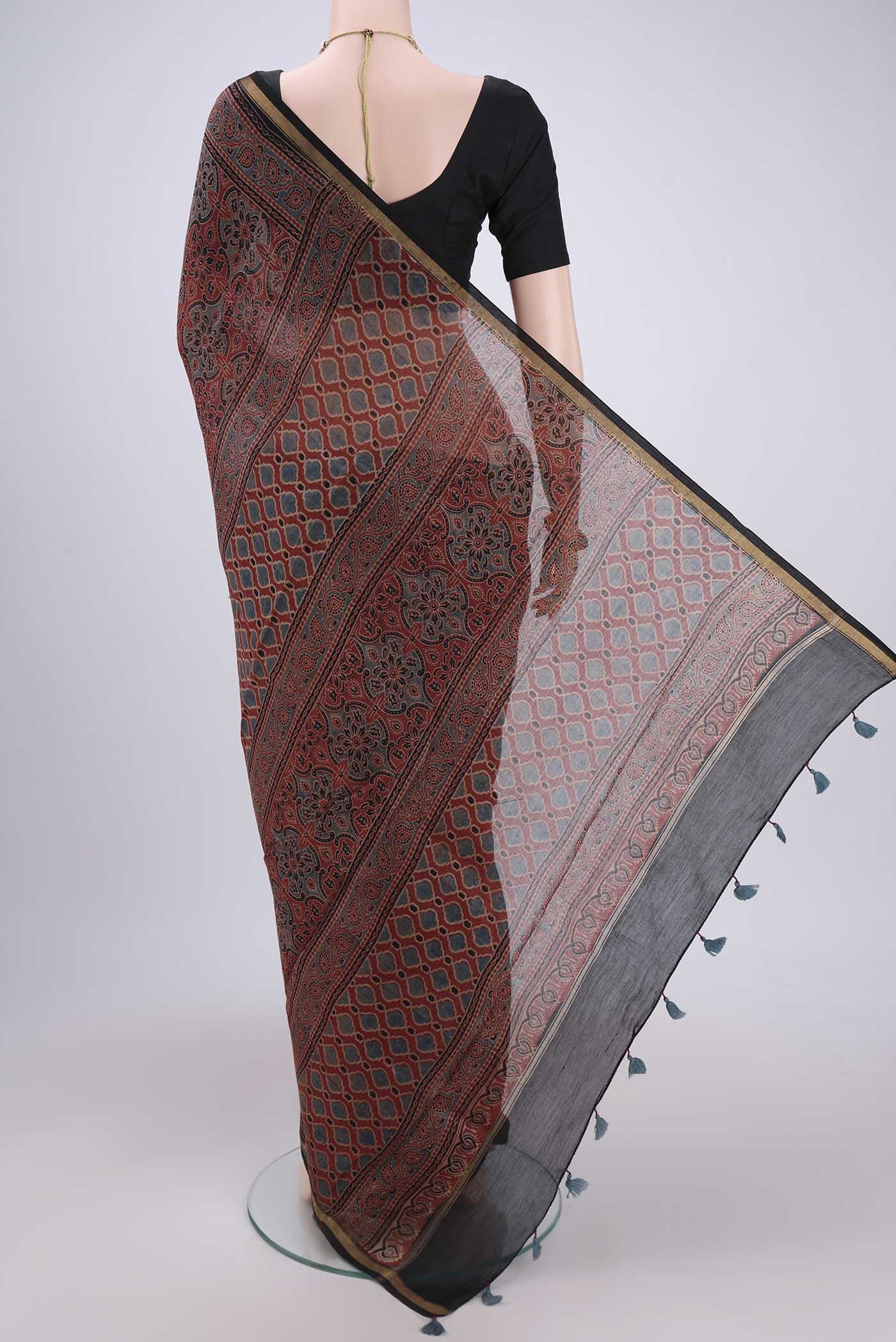 Flat view of Maroon Chanderi Silk Cotton Saree with Ajrakh Print on the body and Zari Border. 
