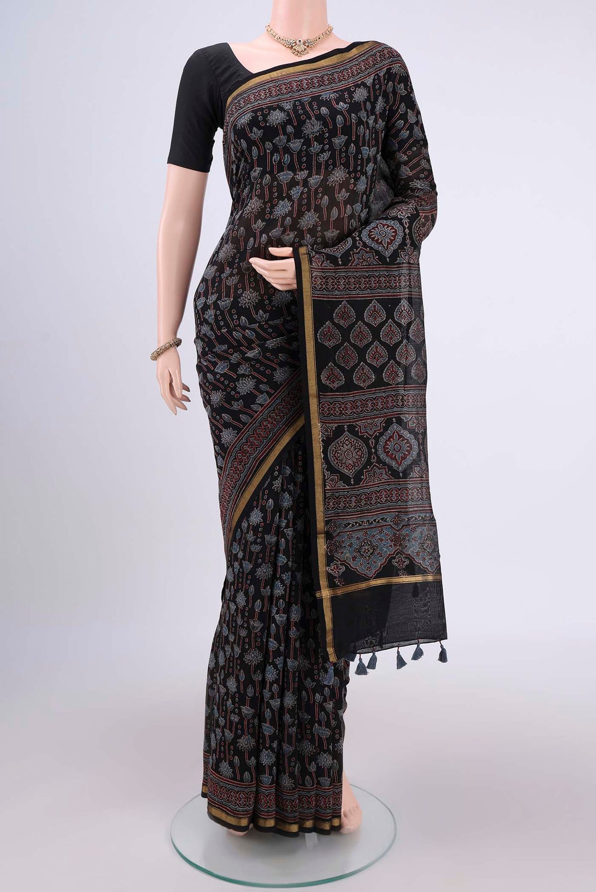 Black Chanderi Silk Cotton Saree with Ajrakh Print on the body and Zari Border.  displayed on a mannequin