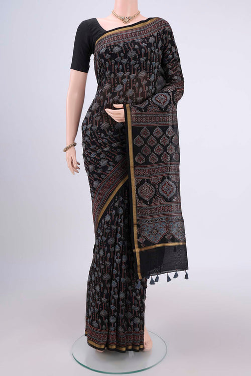 Black Chanderi Silk Cotton Saree with Ajrakh Print on the body and Zari Border.  displayed on a mannequin