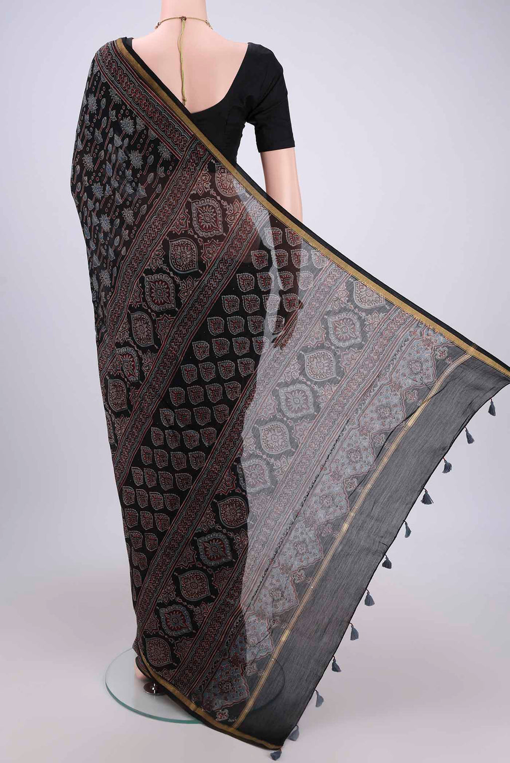 Flat view of Black Chanderi Silk Cotton Saree with Ajrakh Print on the body and Zari Border. 