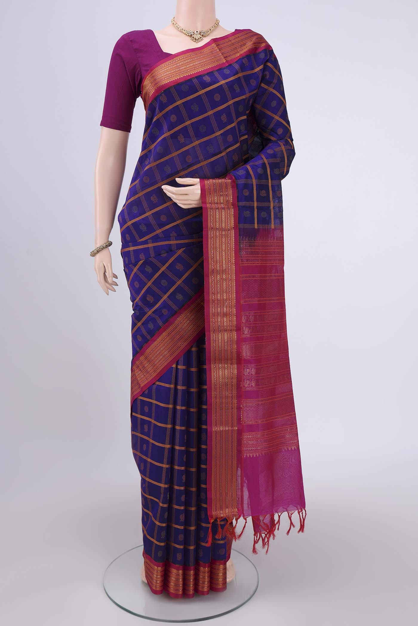 Purple Silk Cotton Saree with Checked design on the body and Plain Border.  displayed on a mannequin