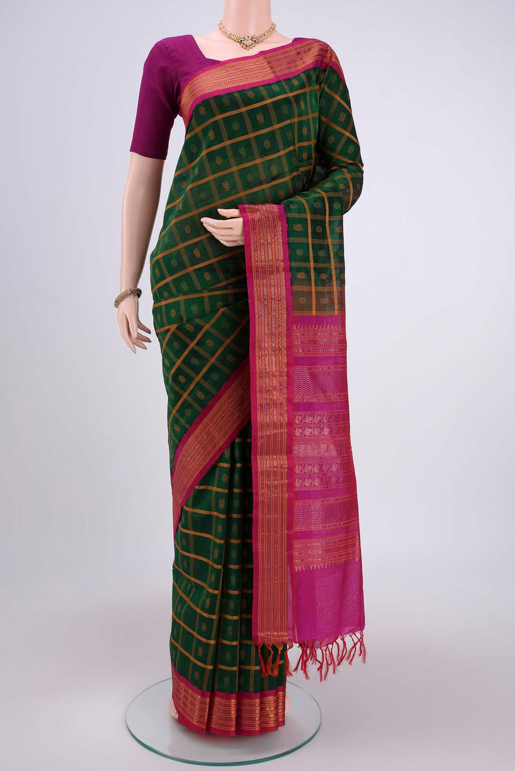 Green Coimbatore Silk Cotton Saree with Stripes on the body and Plain Border.  displayed on a mannequin