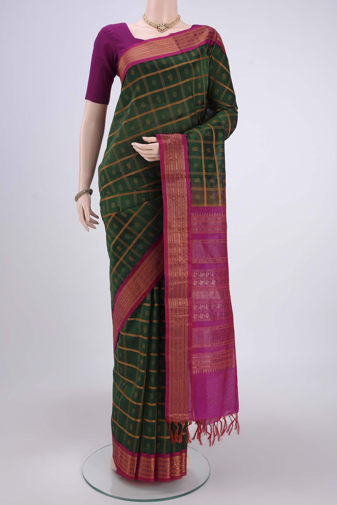 Green Coimbatore Silk Cotton Saree with Stripes on the body and Plain Border.  displayed on a mannequin