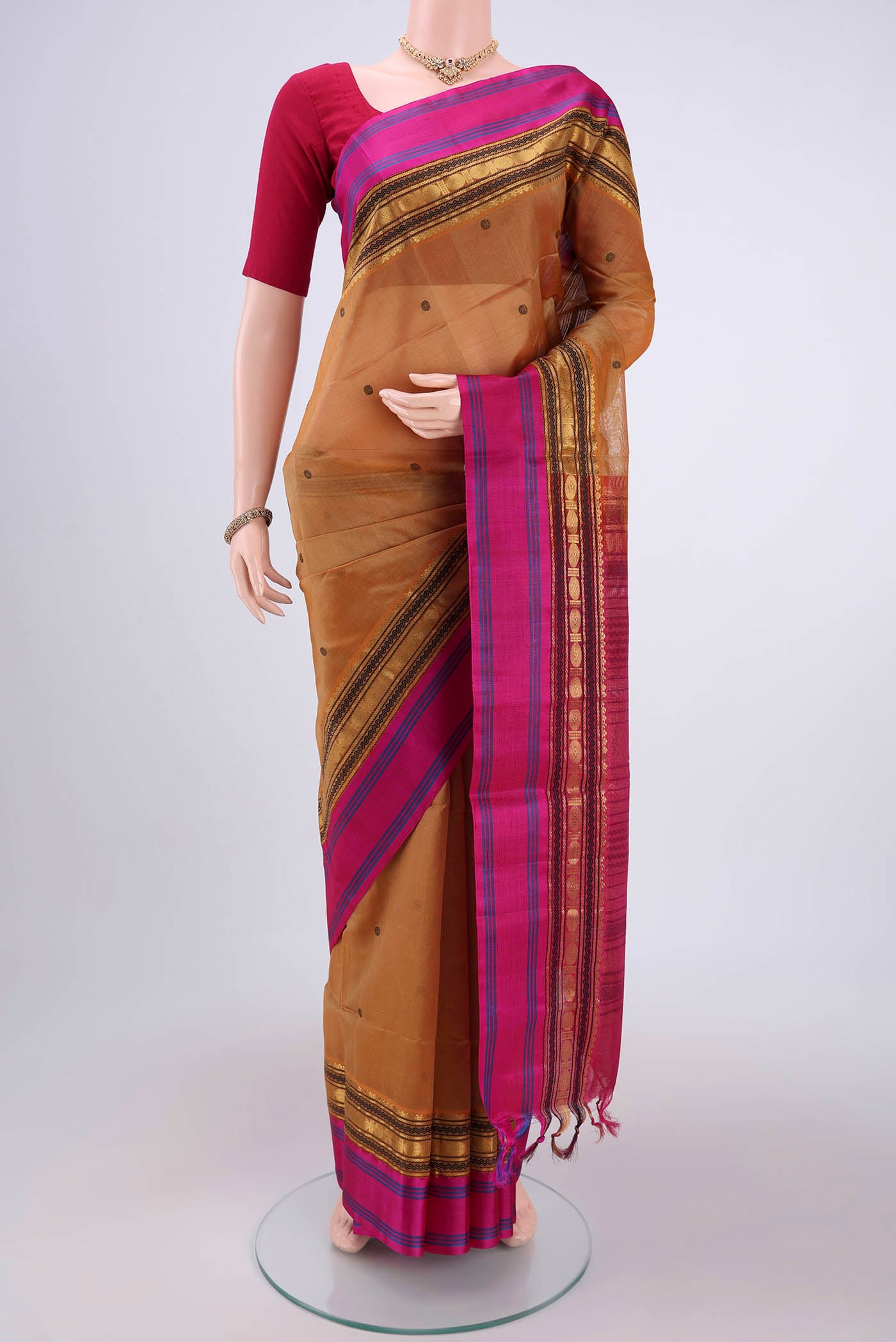 Mustard Coimbatore Silk Cotton Saree with Stripes on the body and Plain Border.  displayed on a mannequin