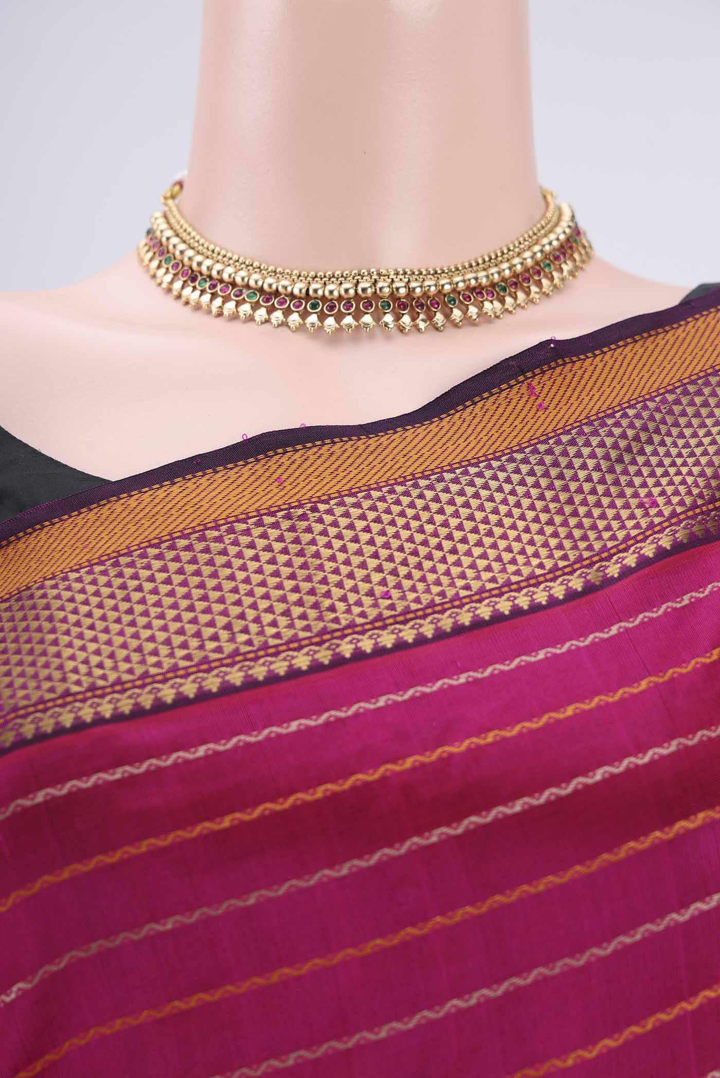 Border image of Rani Pink Silk Cotton Saree with Veldhari on the body and Zari Border. 