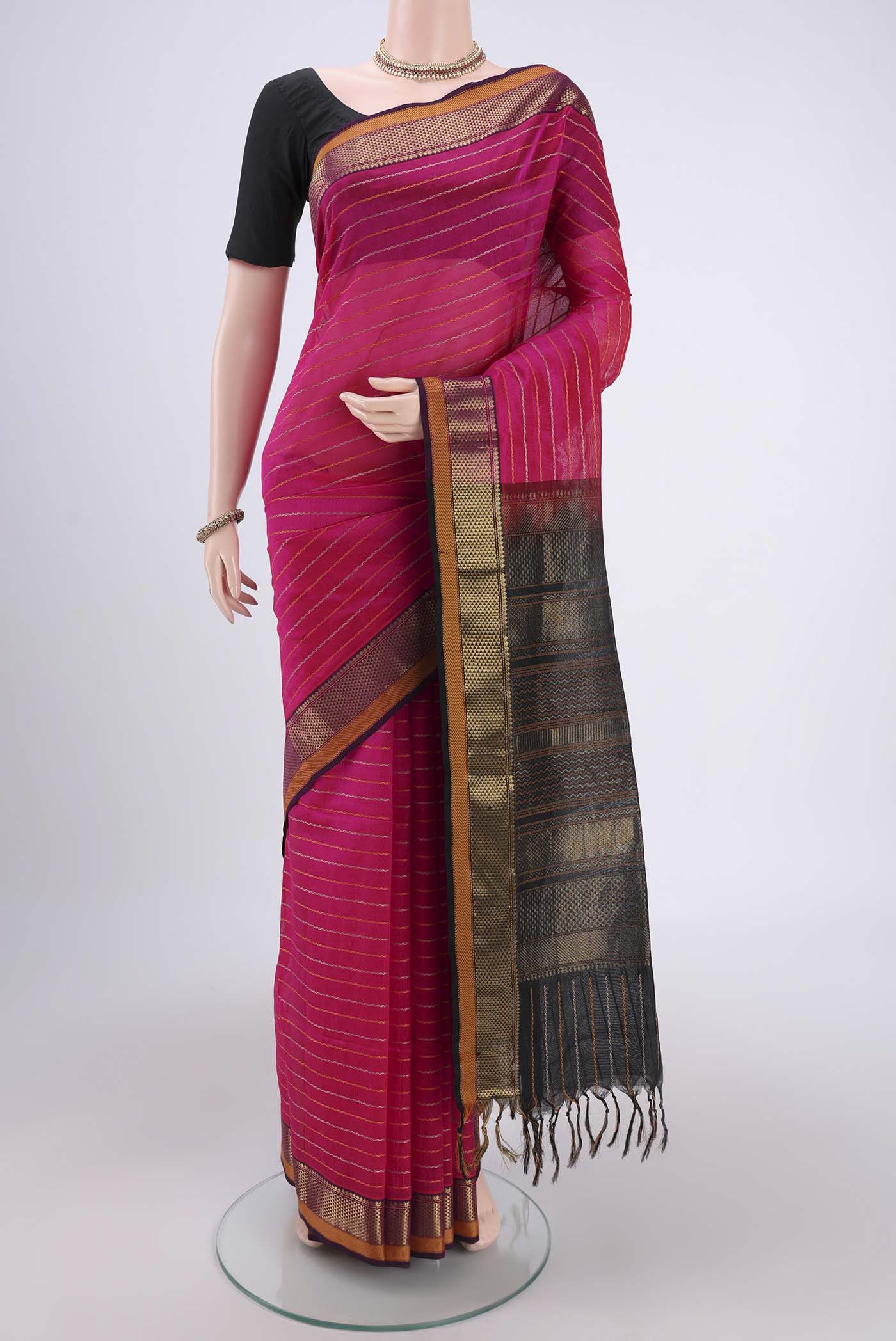 Rani Pink Silk Cotton Saree with Veldhari on the body and Zari Border.  displayed on a mannequin