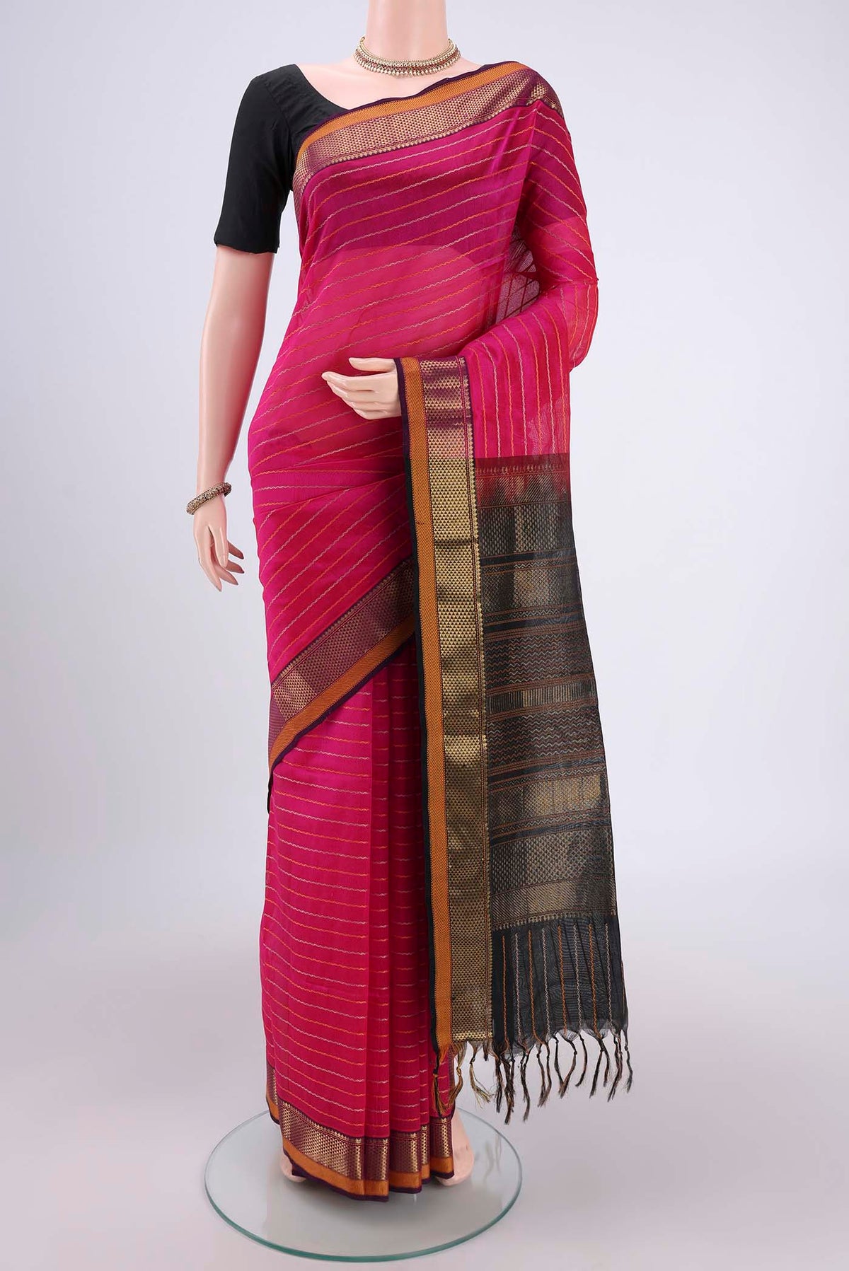 Rani Pink Silk Cotton Saree with Veldhari on the body and Zari Border.  displayed on a mannequin