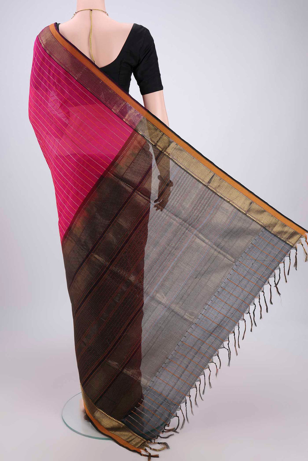 Flat view of Rani Pink Silk Cotton Saree with Veldhari on the body and Zari Border. 
