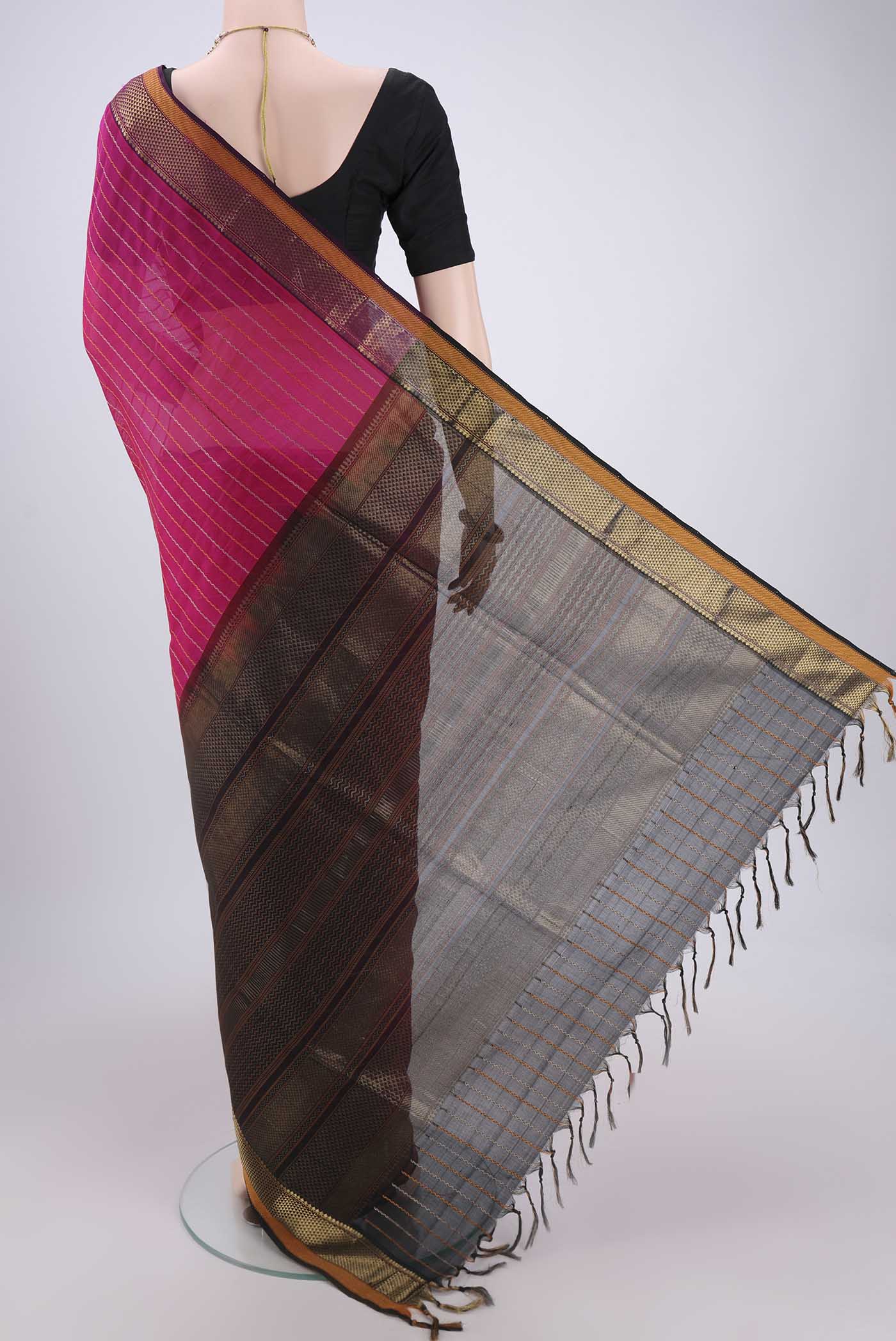 Flat view of Rani Pink Silk Cotton Saree with Veldhari on the body and Zari Border. 