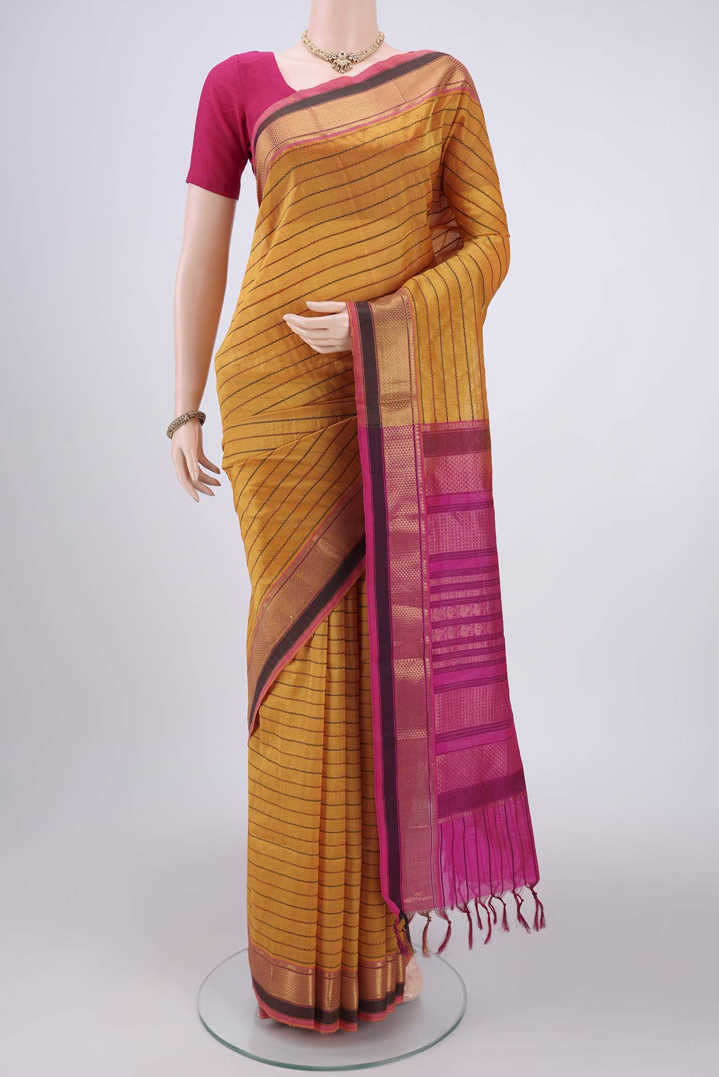 Yellow Coimbatore Silk Cotton Saree with Stripes on the body and Plain Border.  displayed on a mannequin