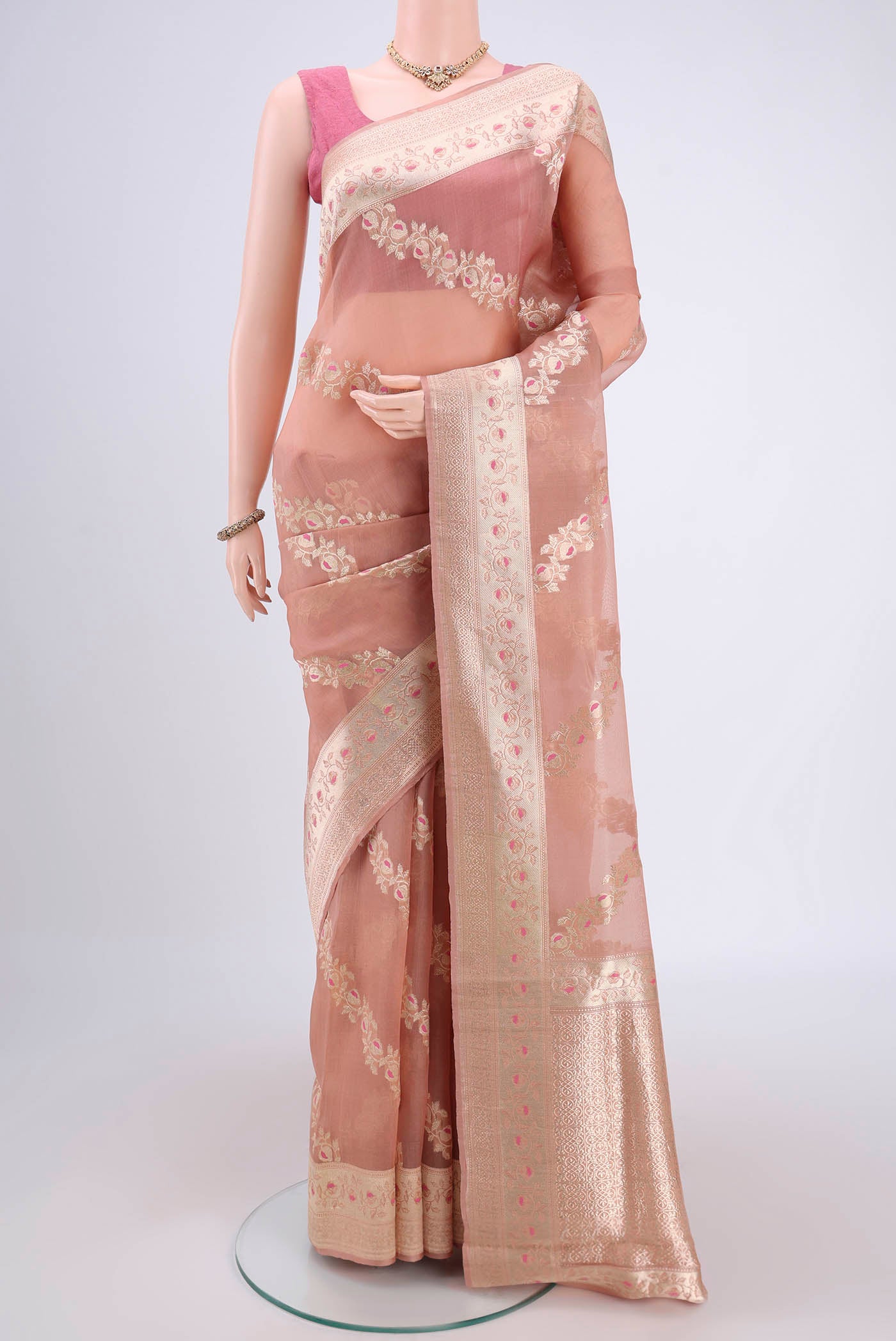 Peach Kora Silk Saree with Zari Brocade on the body and Zari Border.  displayed on a mannequin