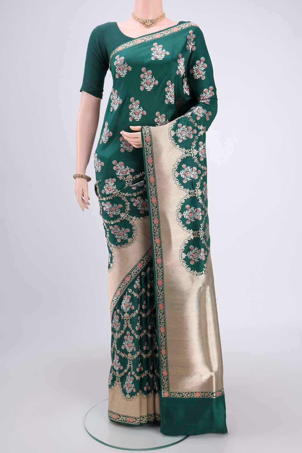 Bottle Green Banarasi Saree with Zari Brocade on the body and Zari Border.  displayed on a mannequin