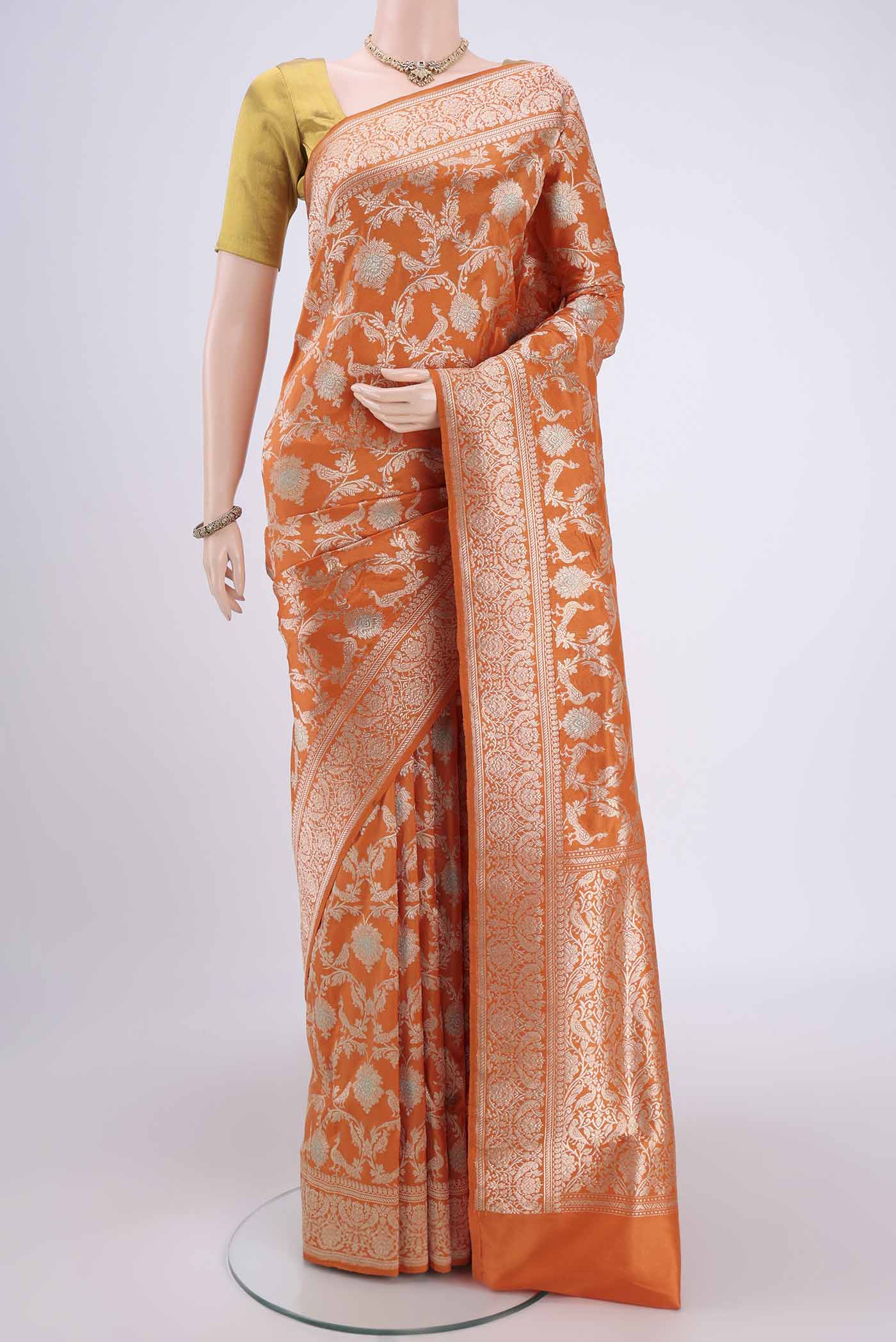 Orange Banarasi Saree with Zari Brocade on the body and Zari Border.  displayed on a mannequin