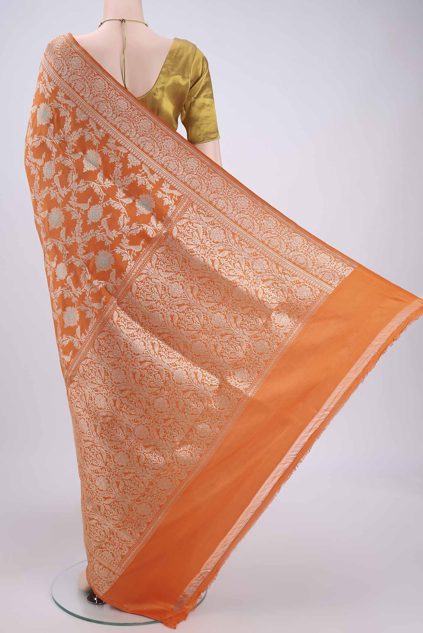Flat view of Orange Banarasi Saree with Zari Brocade on the body and Zari Border. 