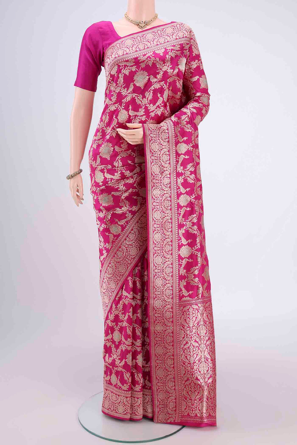 Rani Pink Banarasi Saree with Zari Brocade on the body and Zari Border.  displayed on a mannequin