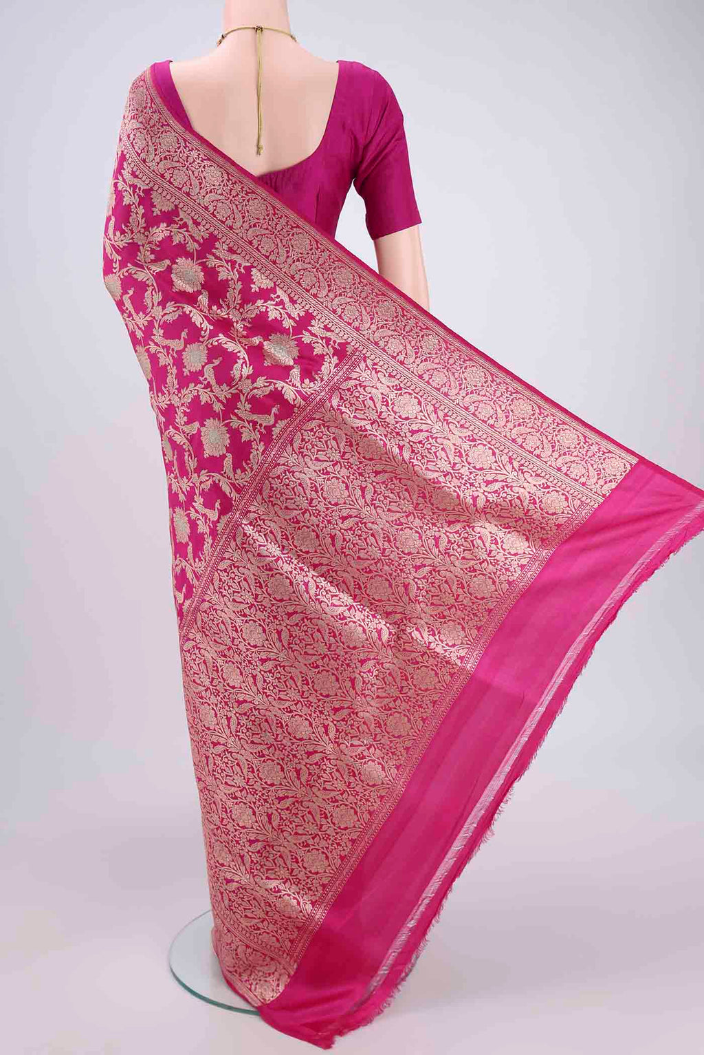 Flat view of Rani Pink Banarasi Saree with Zari Brocade on the body and Zari Border. 