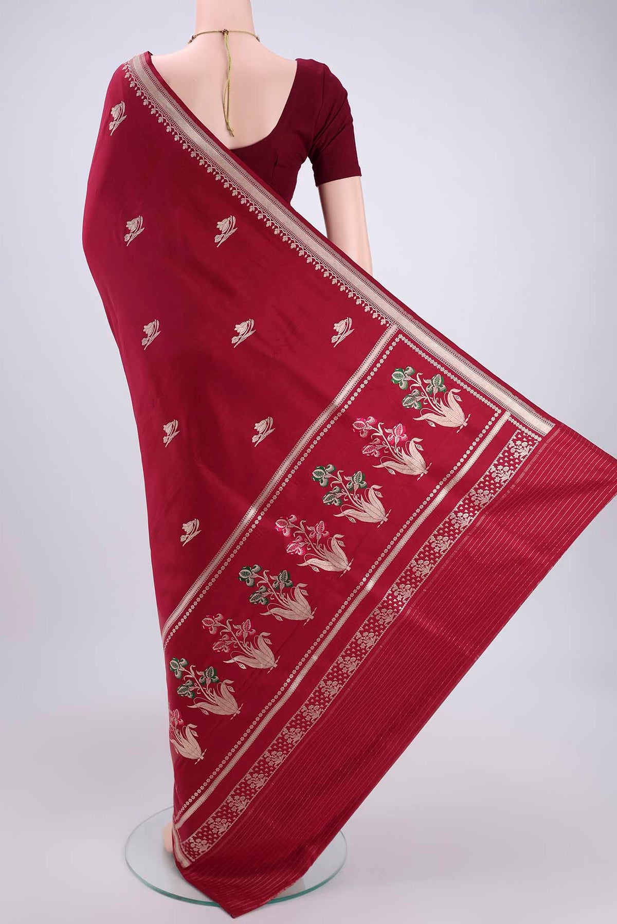 Flat view of Maroon Banarasi Saree with Zari Butta on the body and Zari And Thread Border. 