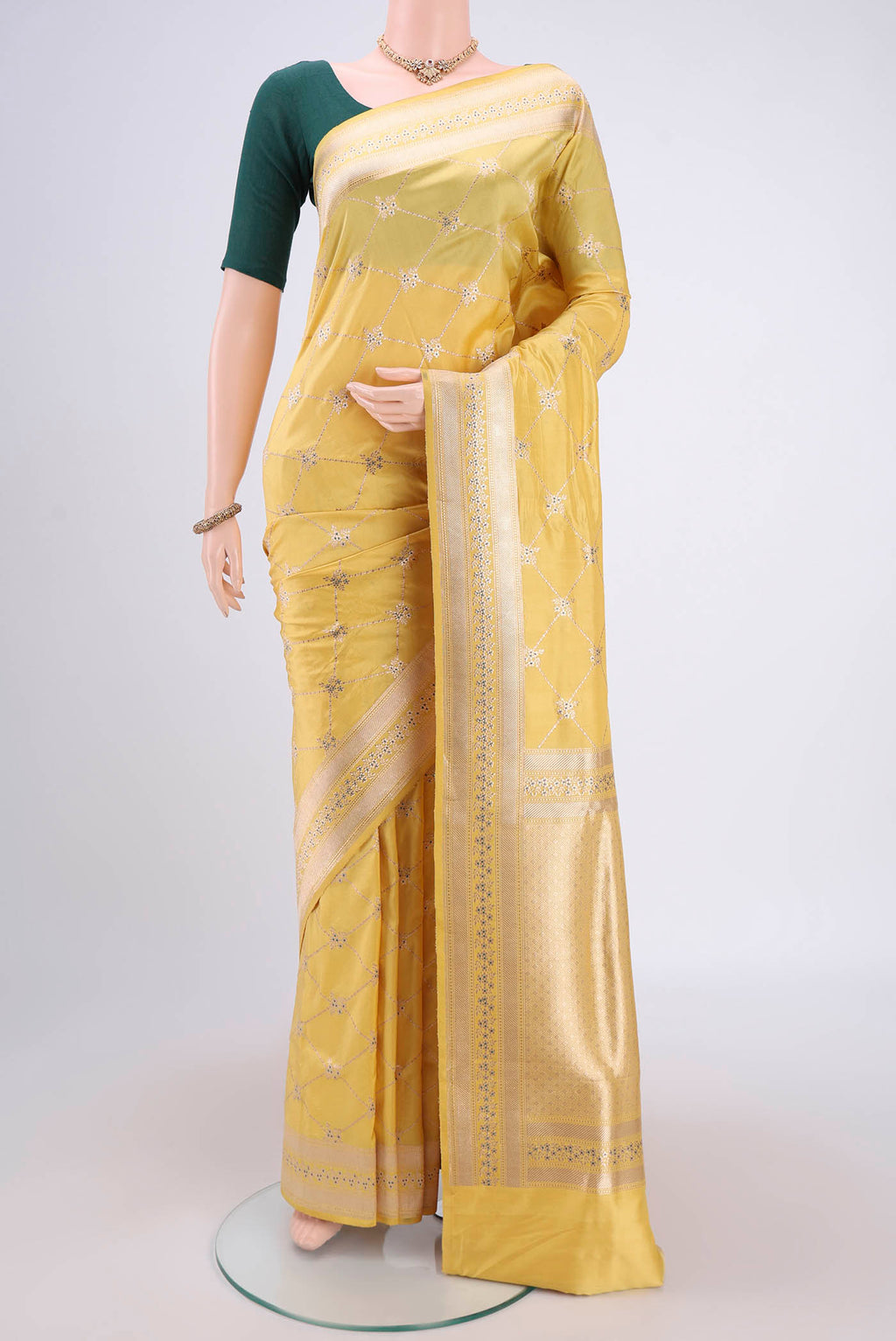 Lemon Yellow Banarasi Saree with Zari Brocade on the body and Zari Border.  displayed on a mannequin