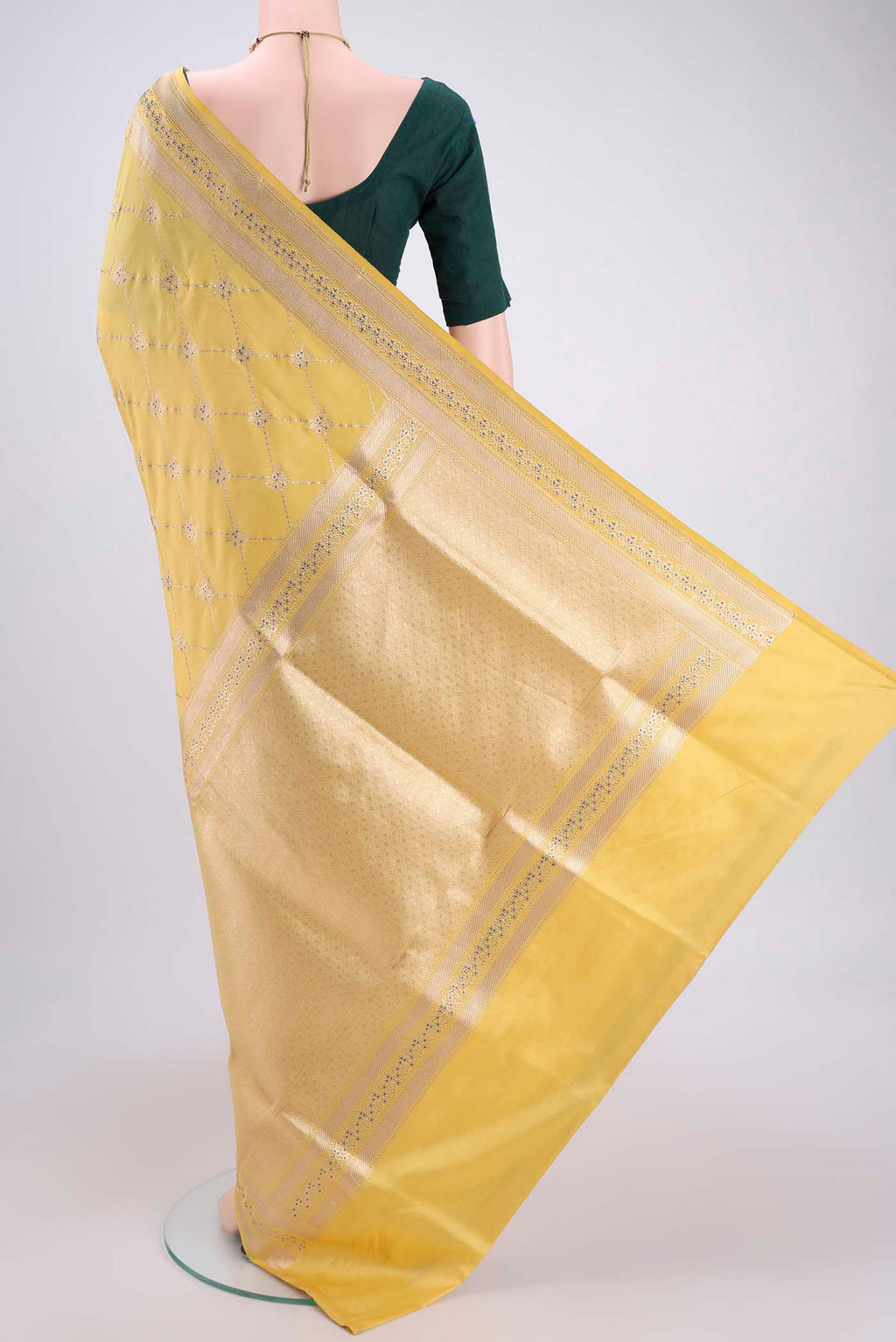 Flat view of Lemon Yellow Banarasi Saree with Zari Brocade on the body and Zari Border. 