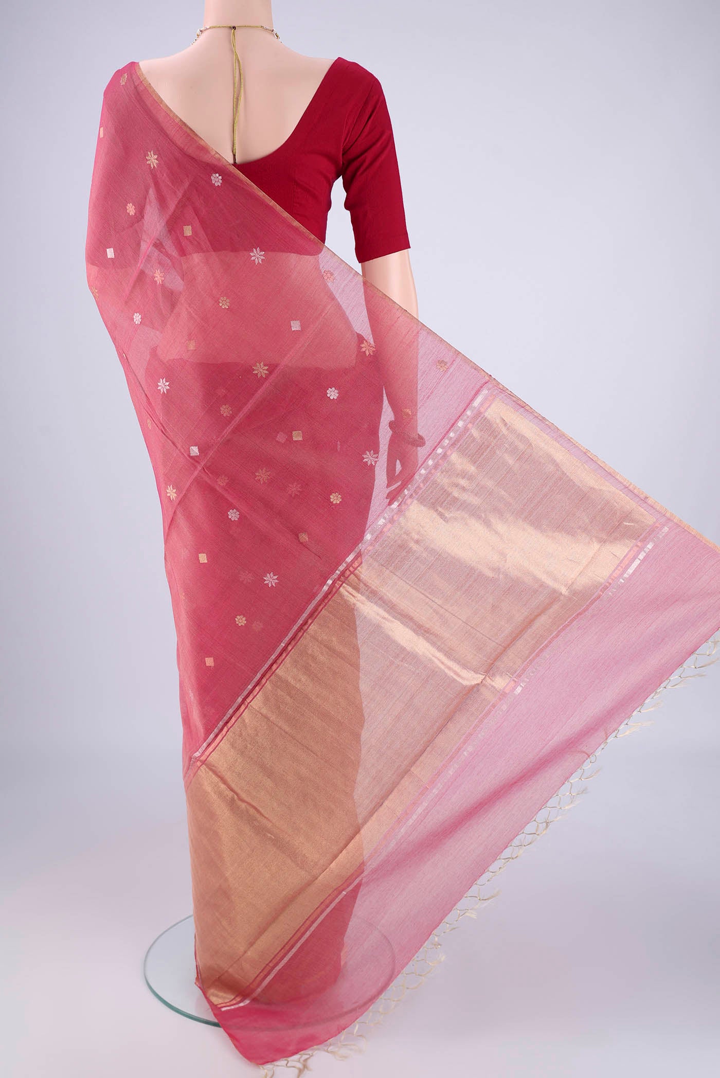 Flat view of Rose pink Tussar Silk Saree with Zari Butta on the body and Plain Border. 