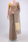 Beige MP Tussar Saree with Zari Butta on the body and Zari Border.  displayed on a mannequin