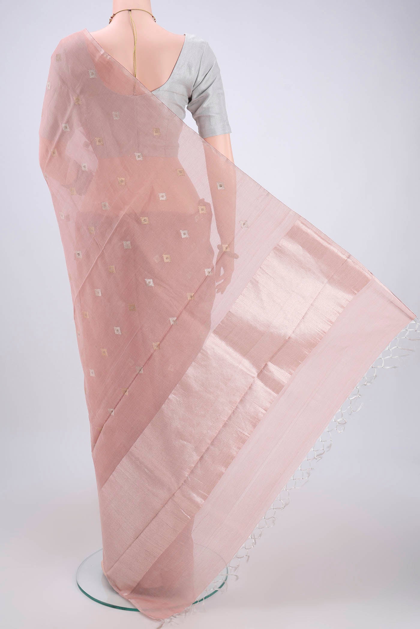 Flat view of Peach MP Tussar Saree with Zari Butta on the body and Zari Border. 