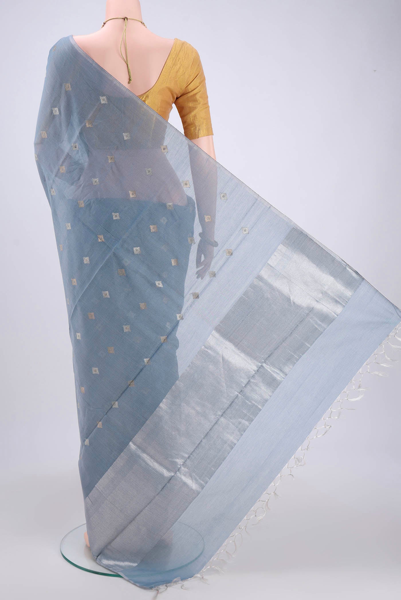 Flat view of Sky Blue MP Tussar Saree with Zari Butta on the body and Zari Border. 