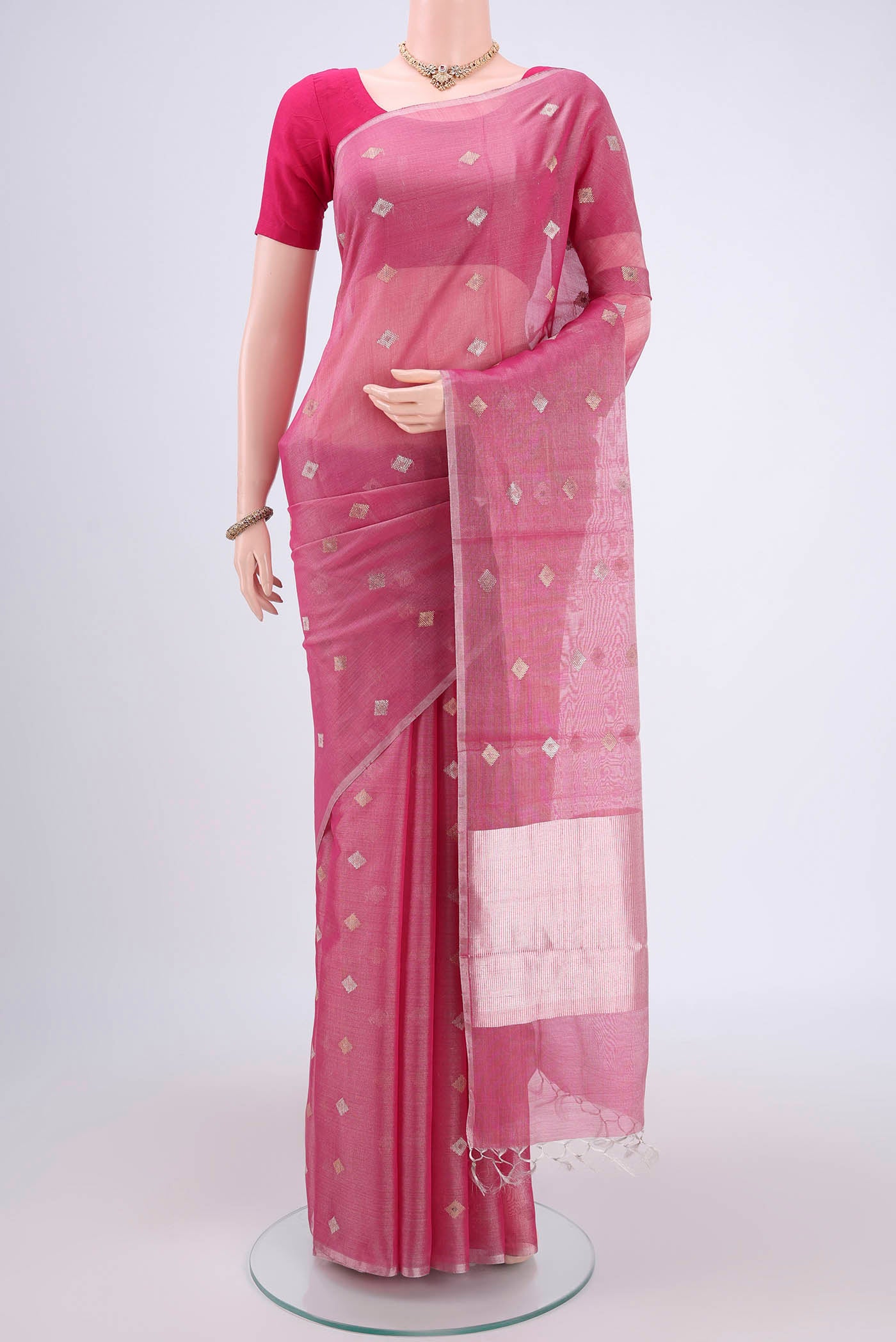 Pink MP Tussar Saree with Zari Butta on the body and Zari Border.  displayed on a mannequin