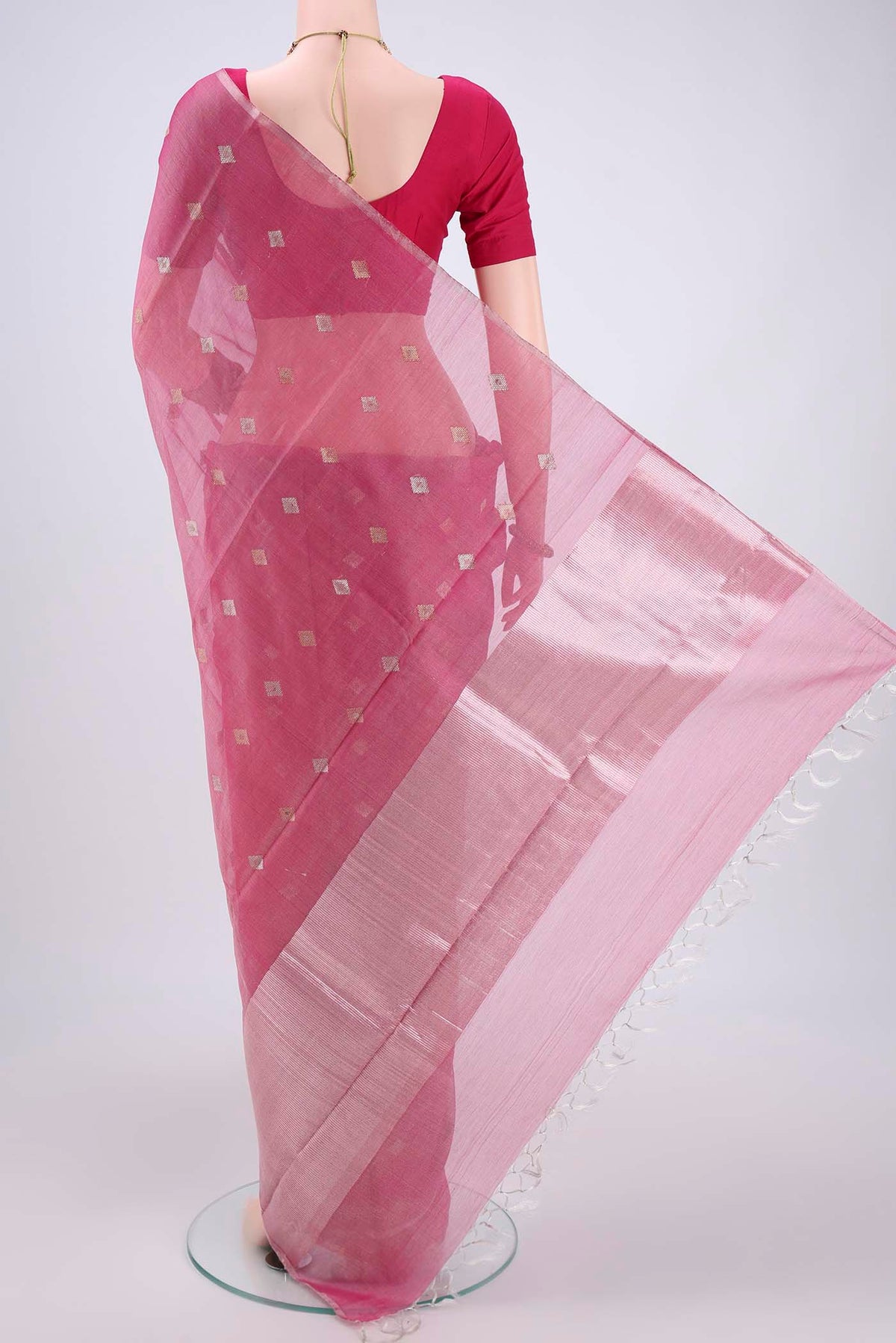 Flat view of Pink MP Tussar Saree with Zari Butta on the body and Zari Border. 