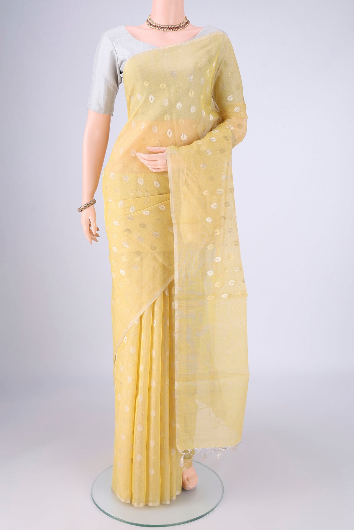 Lemon Yellow MP Tussar Saree with Zari Butta on the body and Thin Zari Line.  displayed on a mannequin